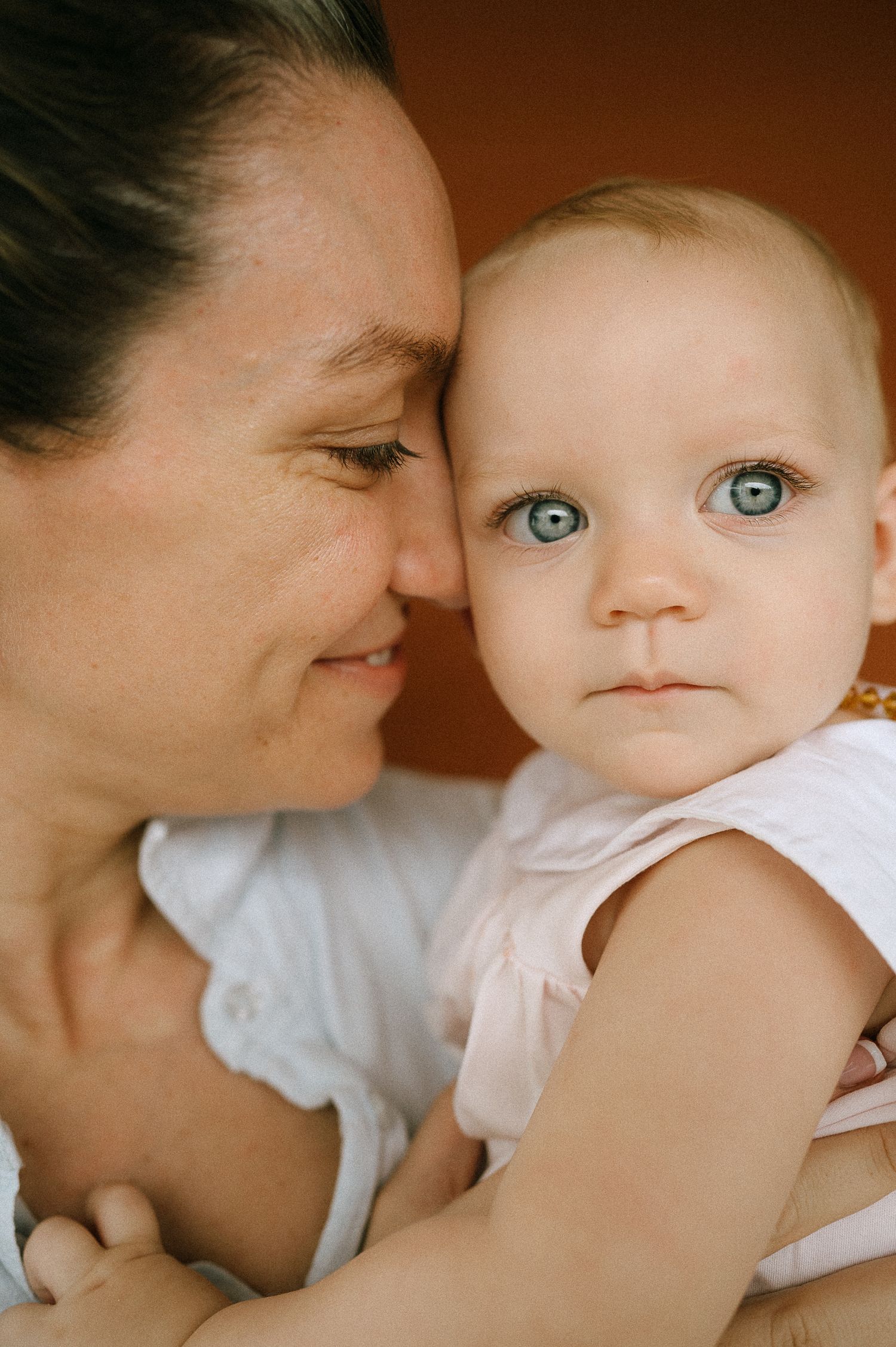 Intimate close-up portrait showing tender parental affection.