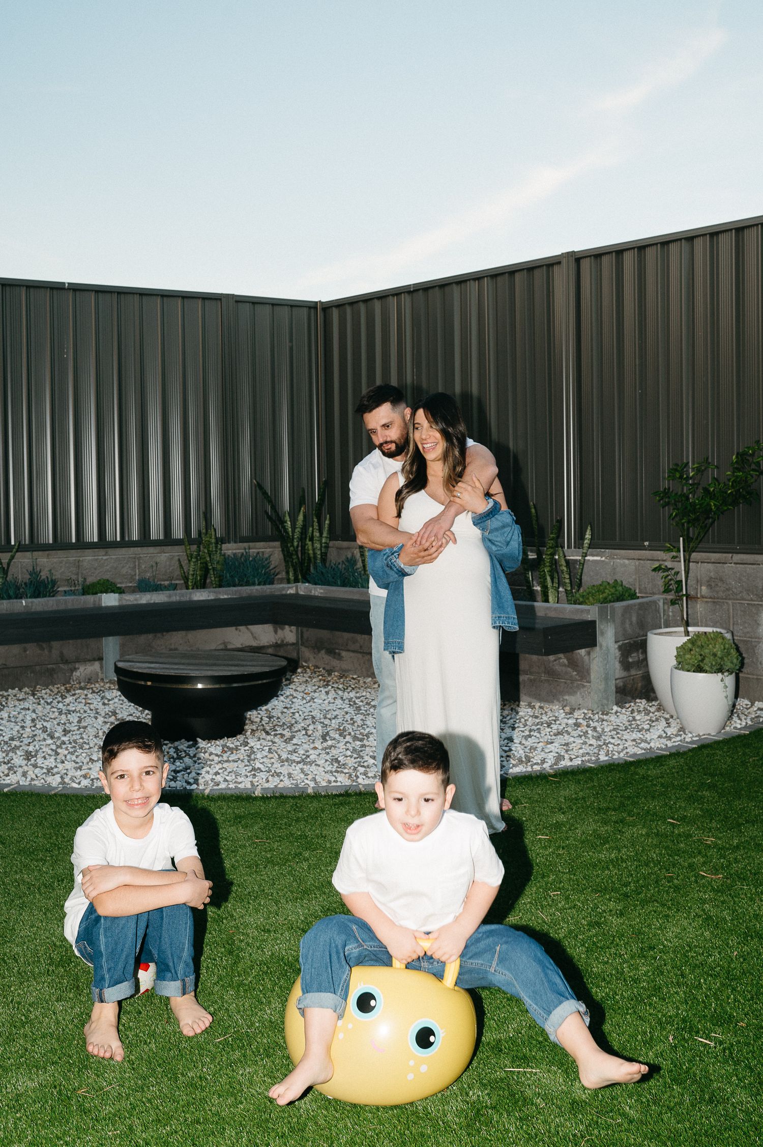 Family having fun with inflatable toys in their backyard.