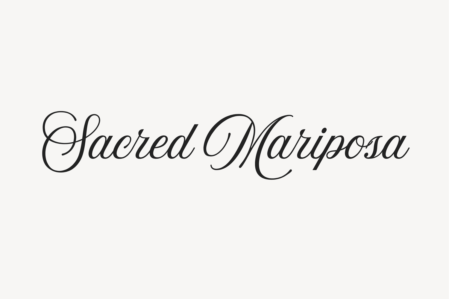 Elegant cursive text reading 'Sacred Mariposa' in black script font on white background.