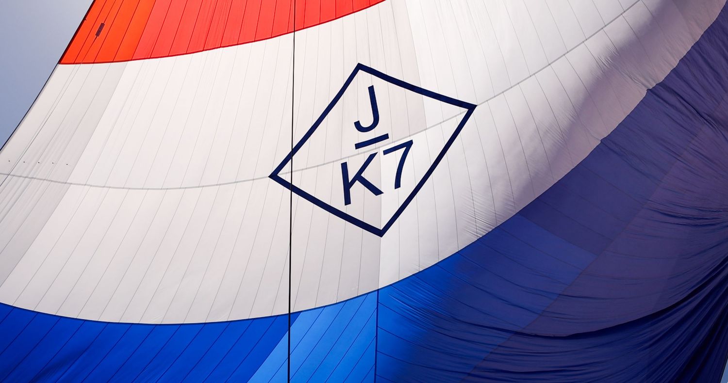 Close-up of red, white and blue sailing spinnaker with racing numbers.