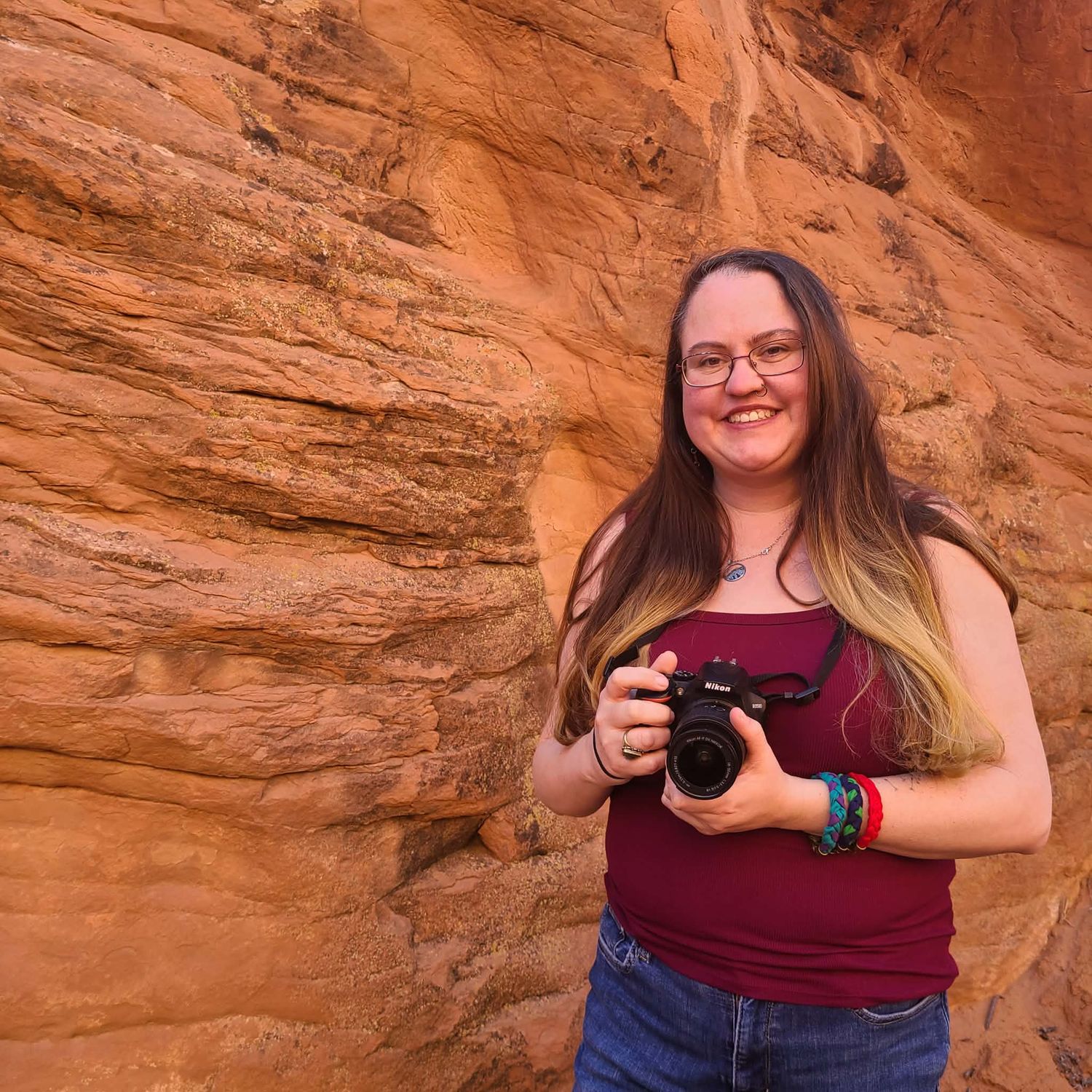 A² Stories associate photographer holding a camera during an outdoor session in Utah