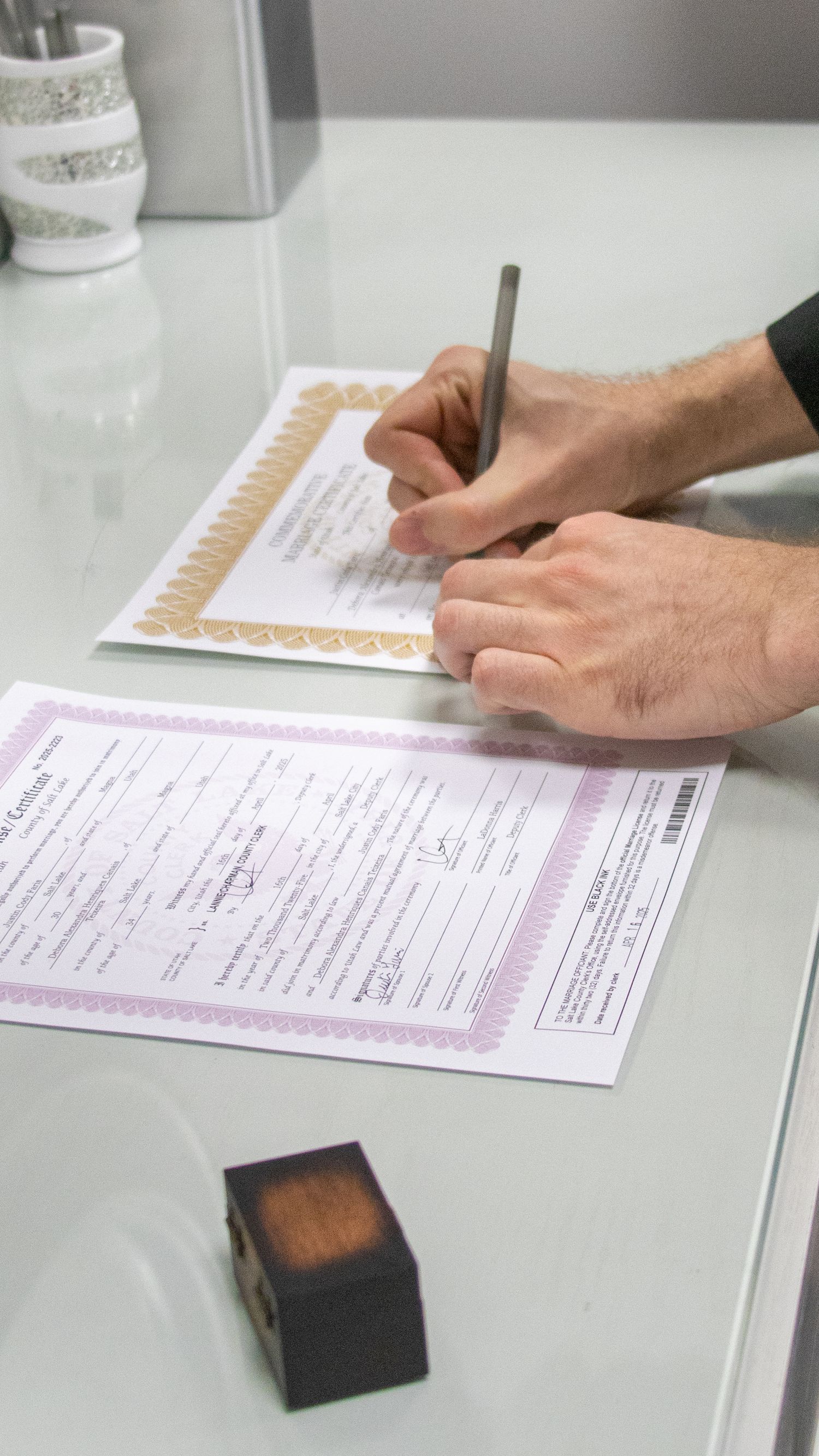 Couple signing marriage documents during a courthouse elopement in Utah