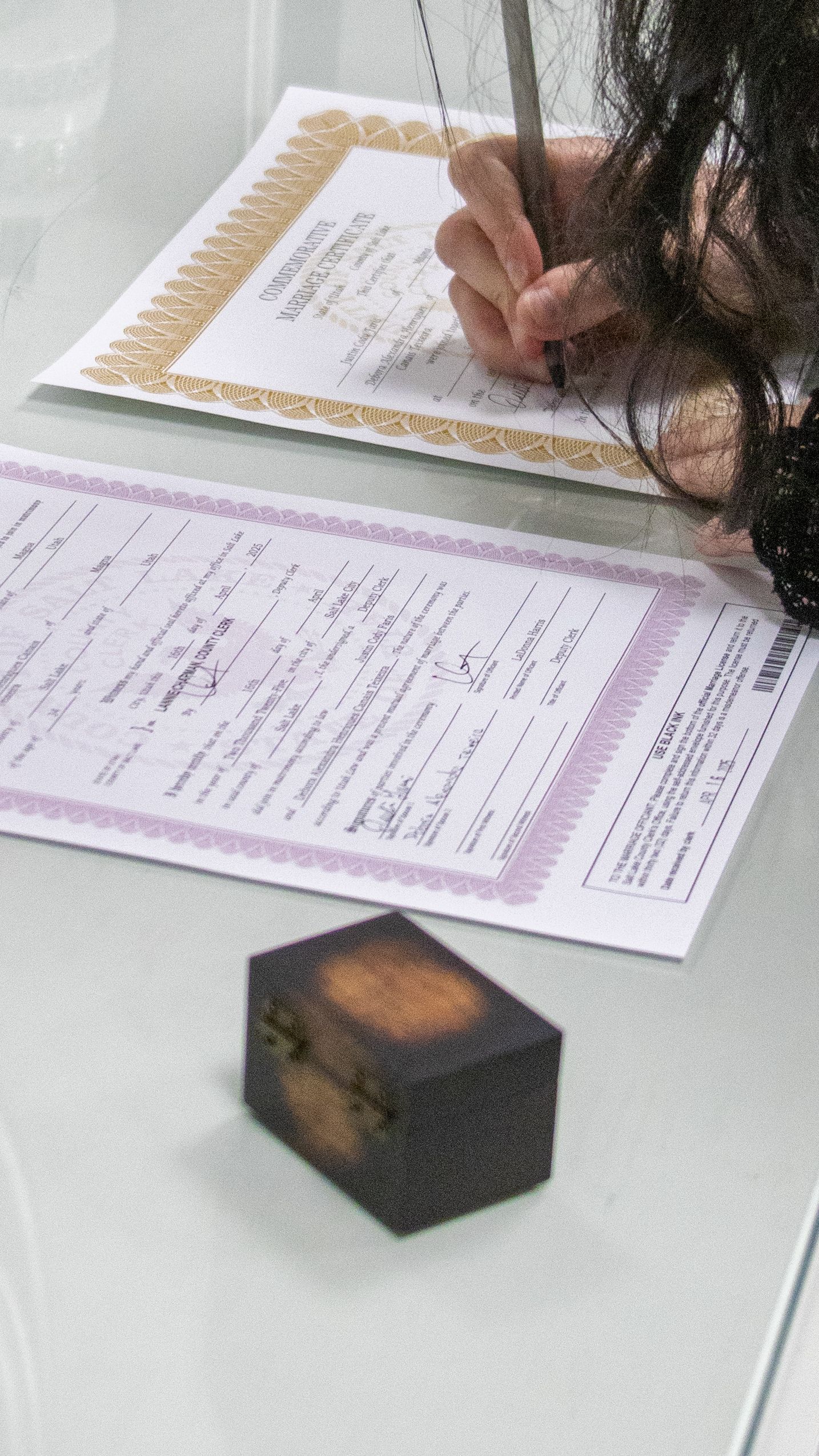 Bride signing marriage license during a courthouse wedding in Salt Lake City, Utah