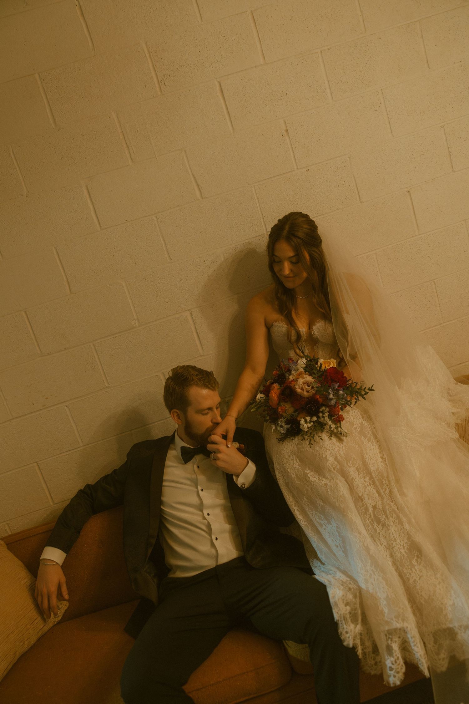 An artistic series of wedding photos showing intimate moments between newlyweds against a beige wall.