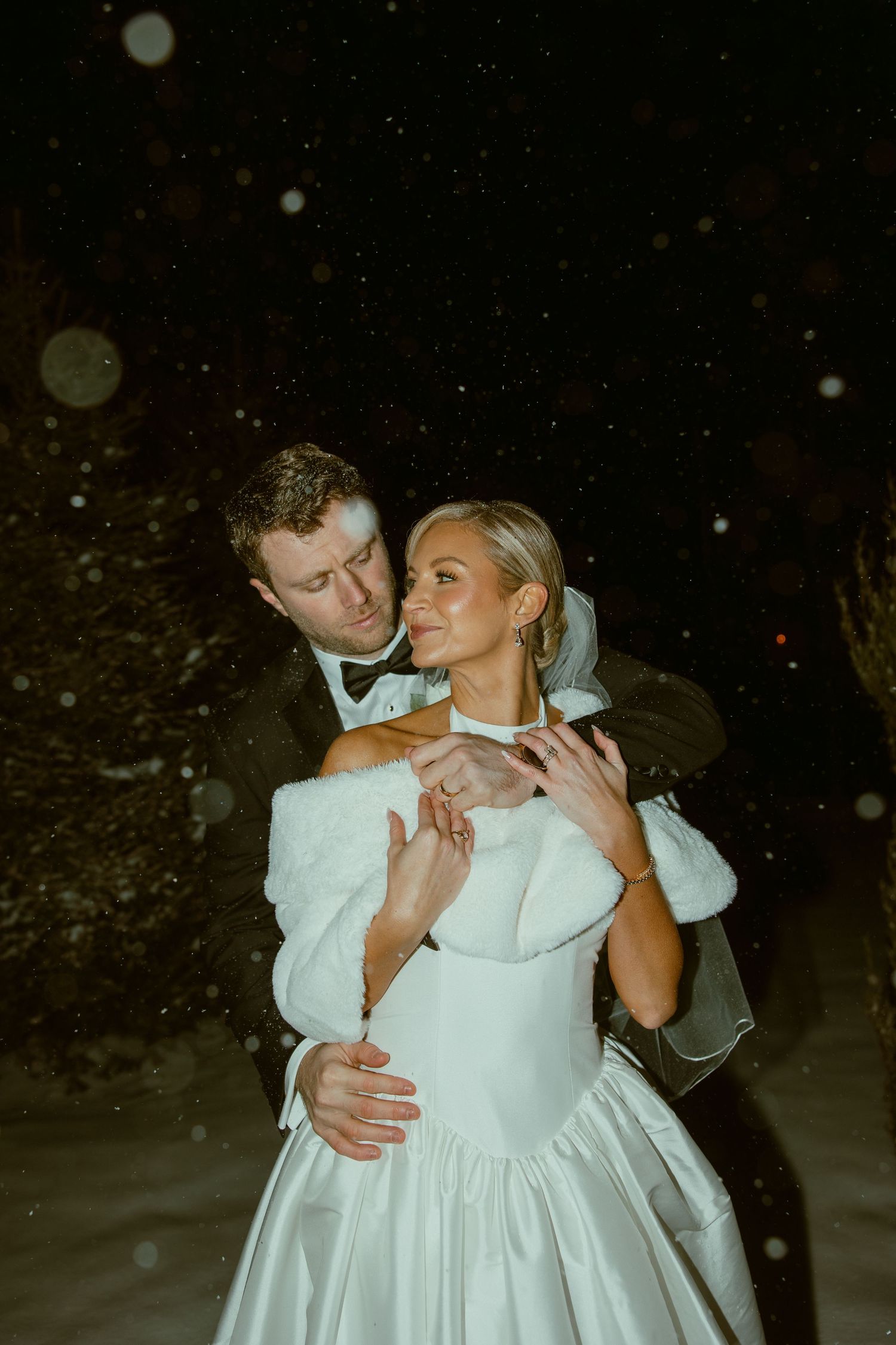 A tender moment between newlyweds during their winter wedding celebration.