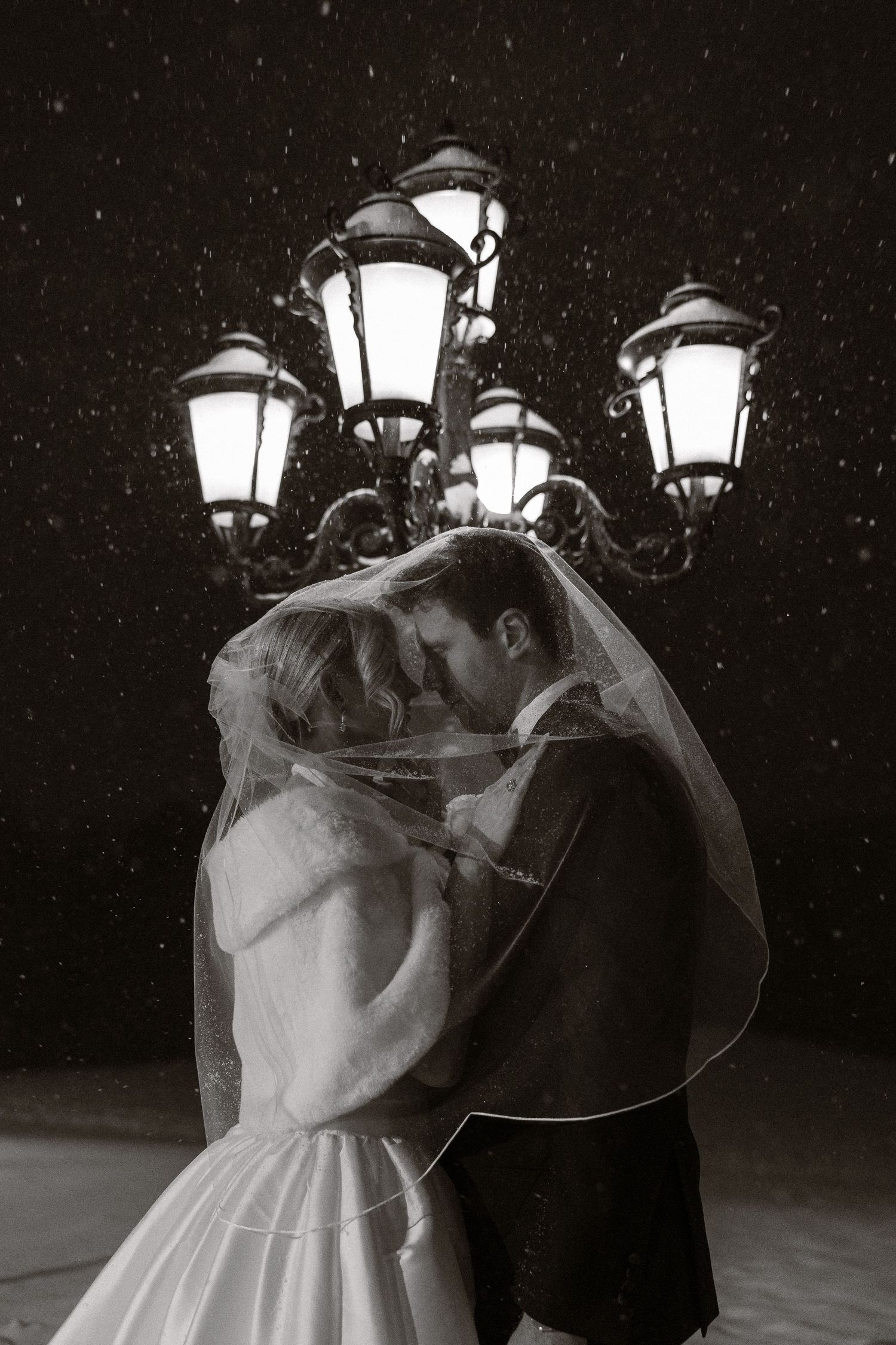 A romantic nighttime dance scene illuminated by glowing vintage street lamps creating a magical atmosphere.