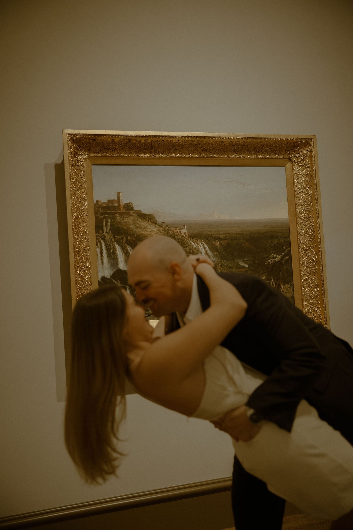 A series of photos showing someone bending backwards while looking at framed artwork in a gallery.