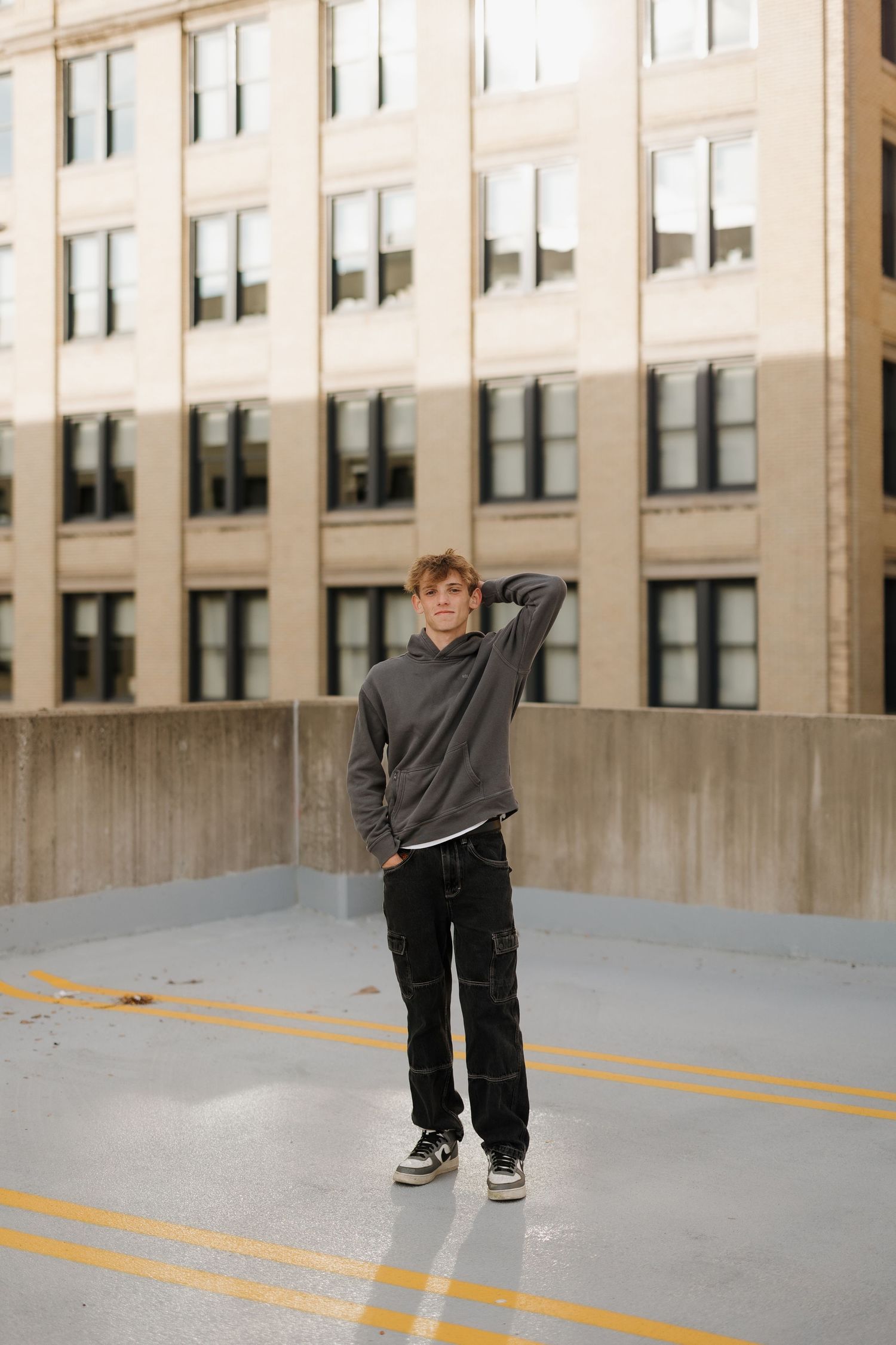 Urban rooftop portrait against a city building background.
