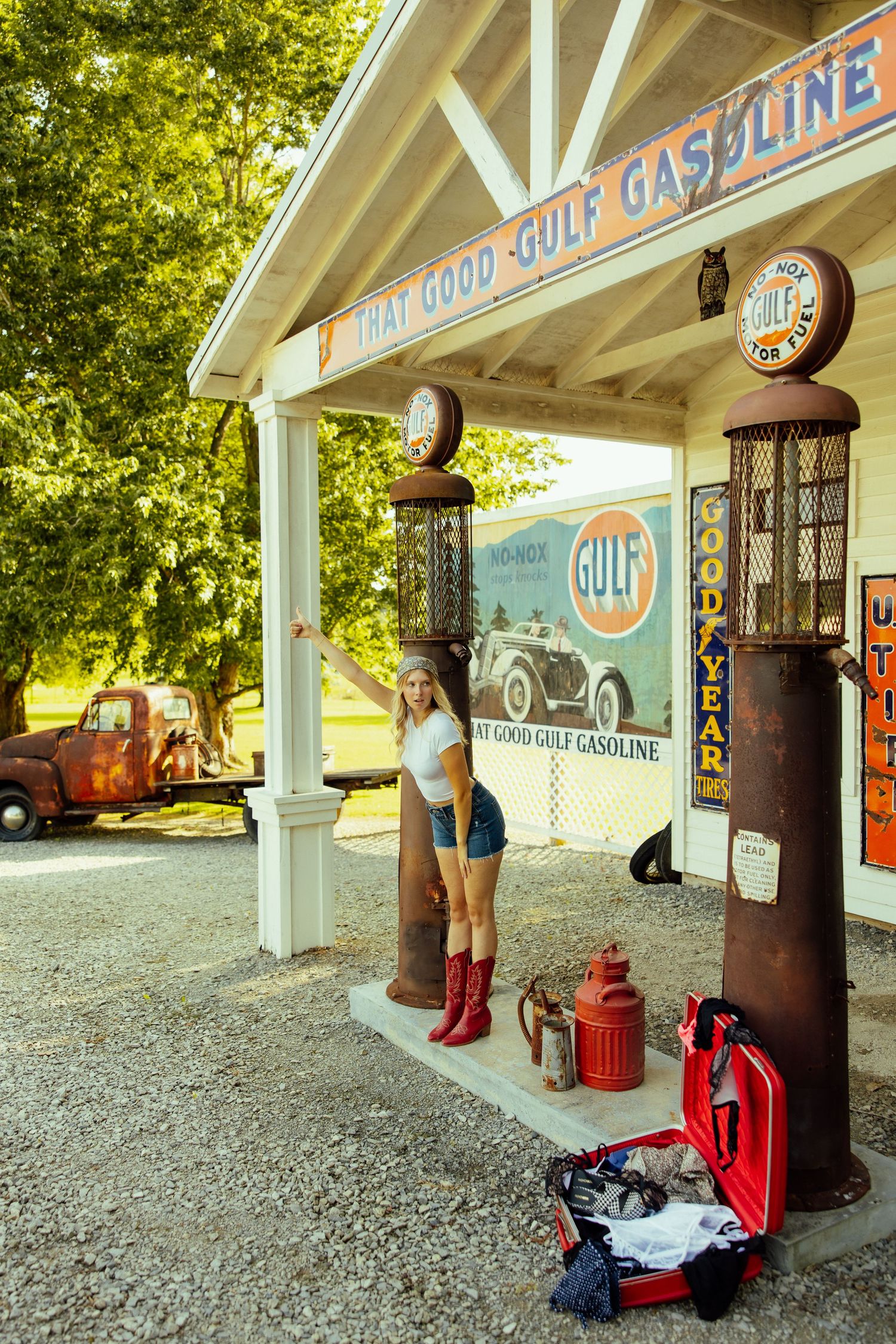 Classic Gulf service station with vintage signage and white-painted wooden beams in sunlit setting.