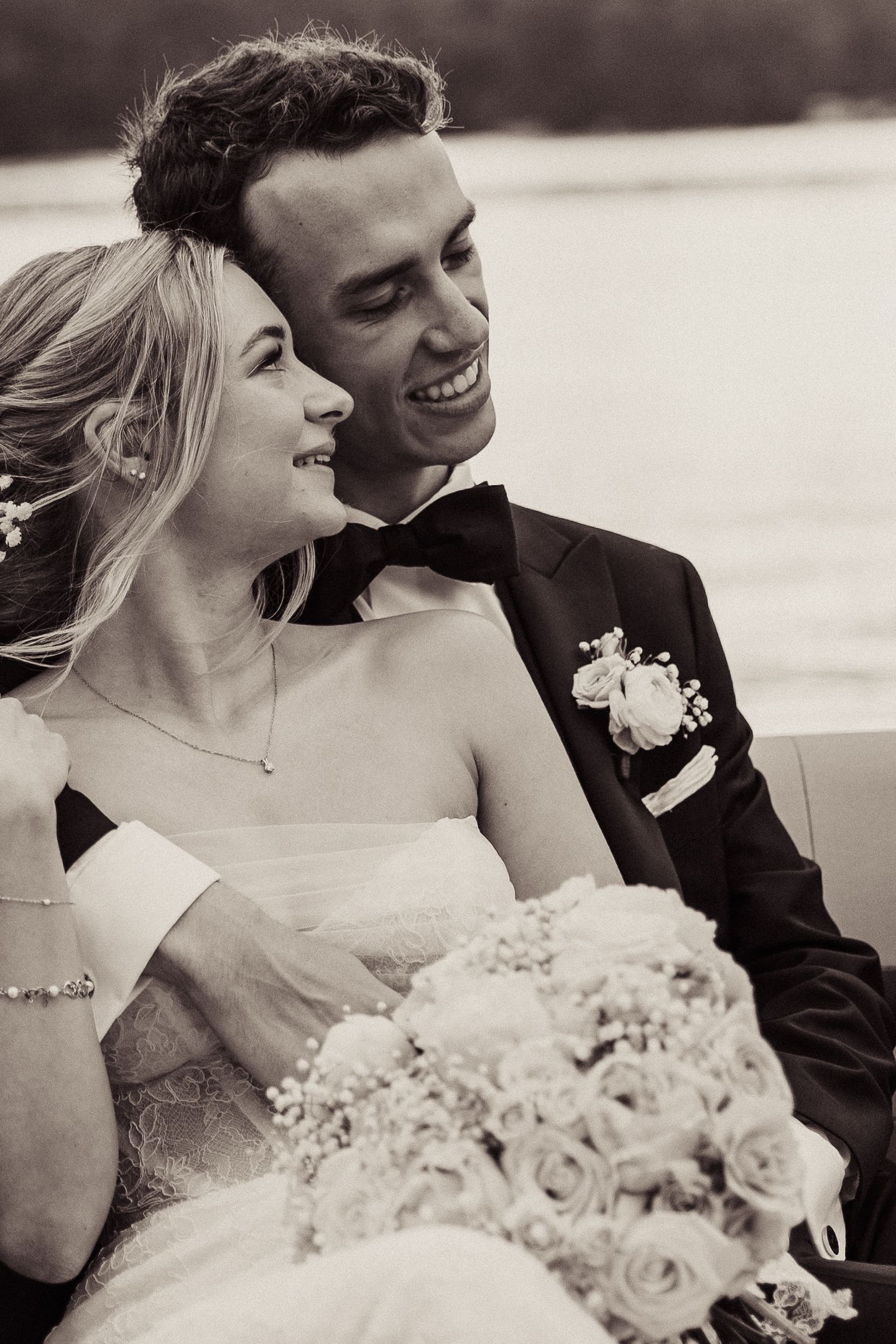 Black and white photo of a romantic wedding moment with a beautiful bouquet of roses.