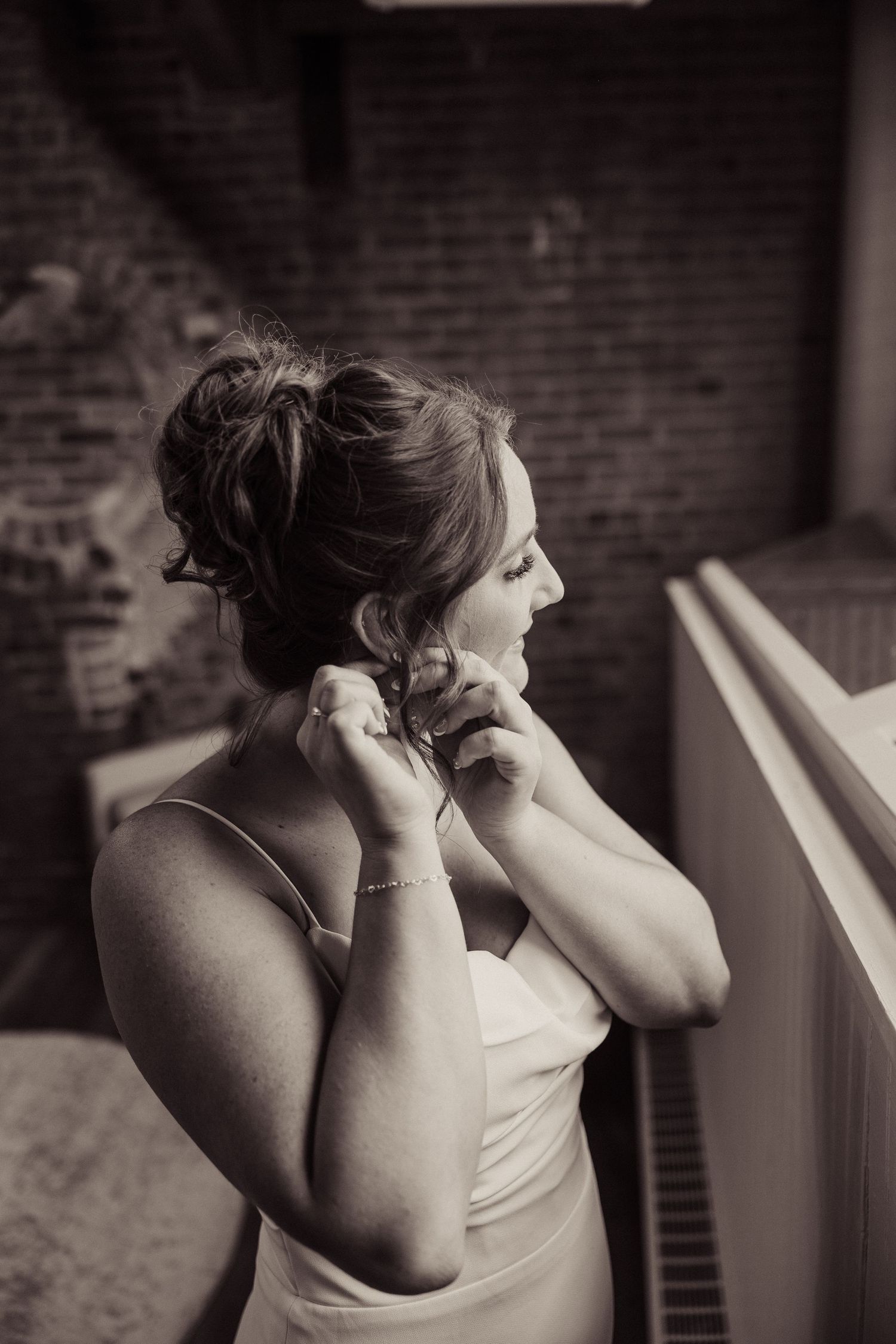 A series of emotional black and white photographs showing candid moments of getting ready on a wedding day.