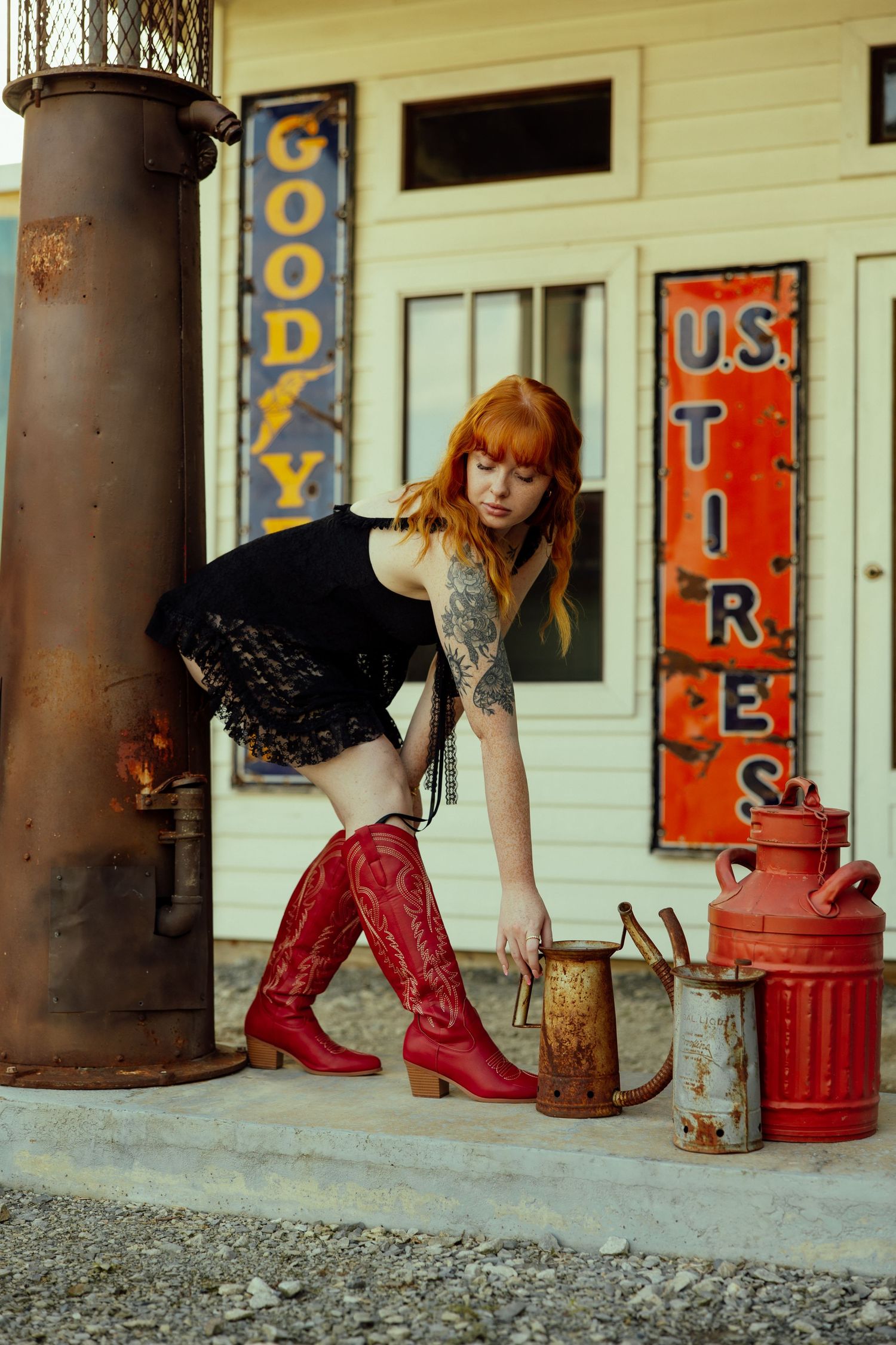 Retro gas station setting with red metal cans and vintage advertising signs on white wooden walls.