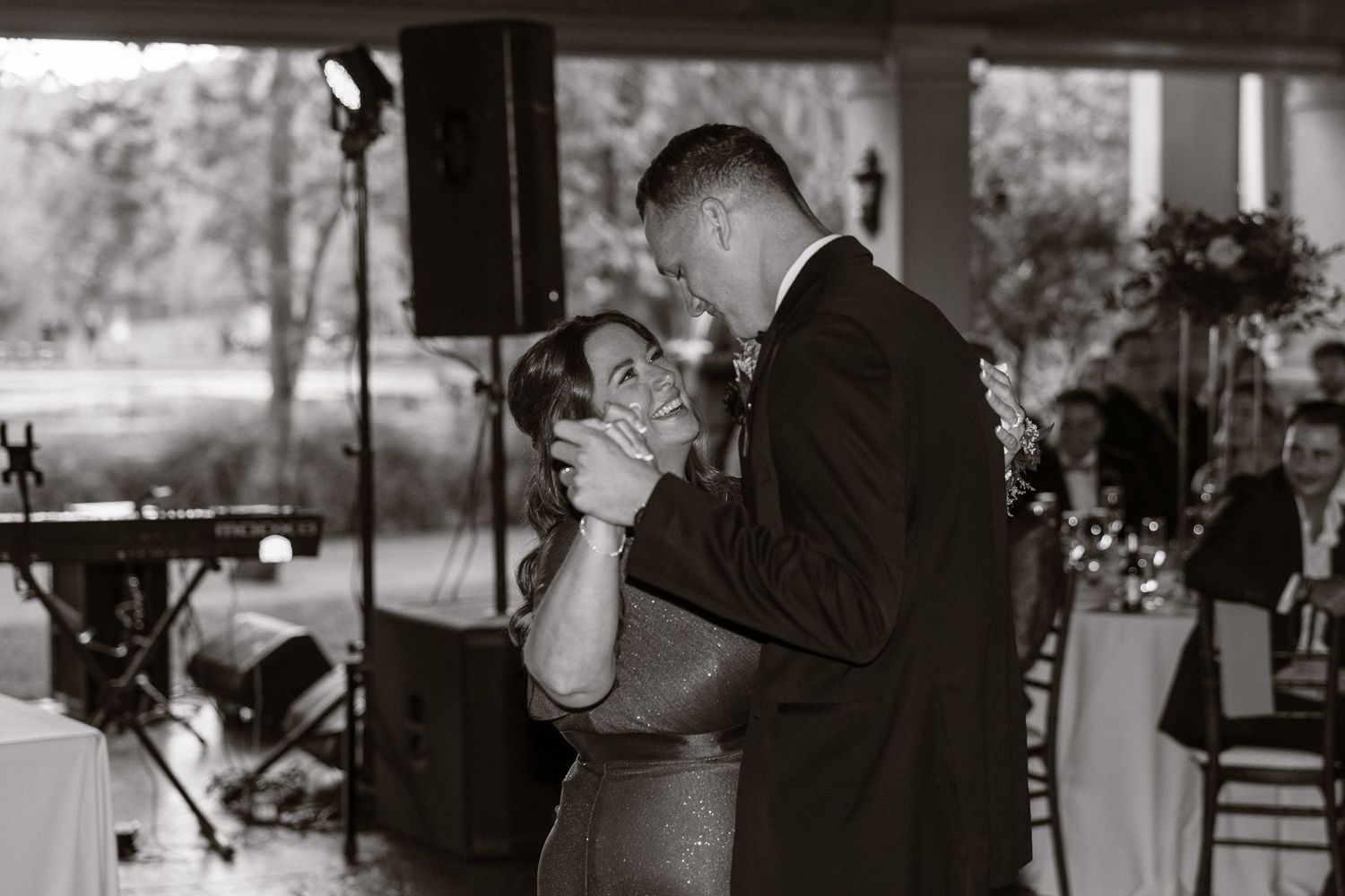 A black and white photo collage showing multiple candid moments from a wedding celebration.
