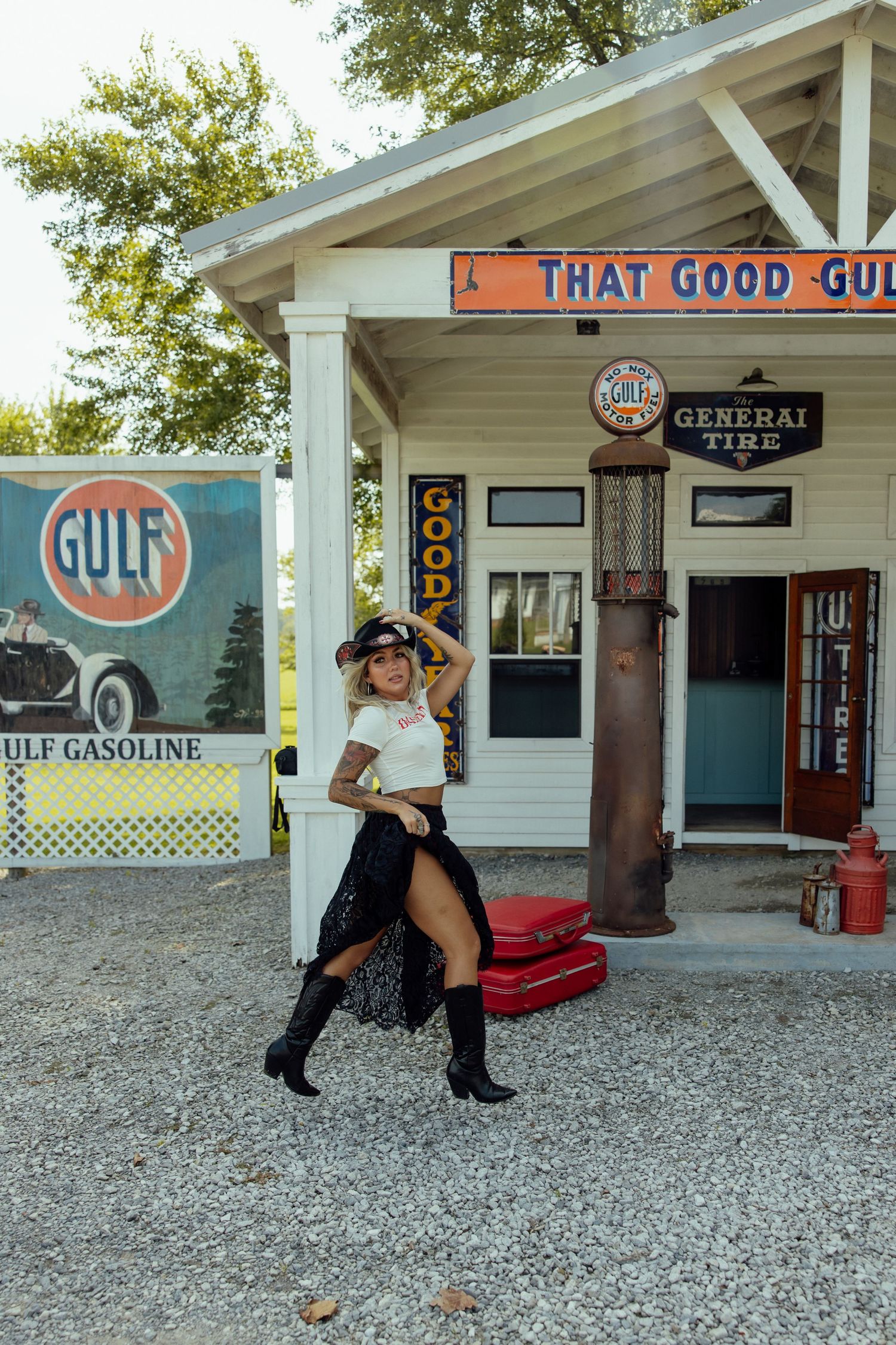 Retro Gulf gas station exterior with white siding and vintage advertising signs.