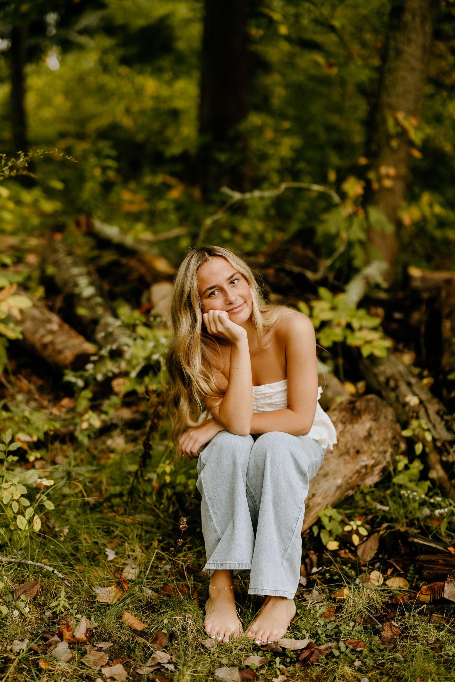 Natural woodland portrait with soft lighting and casual styling in forest setting.