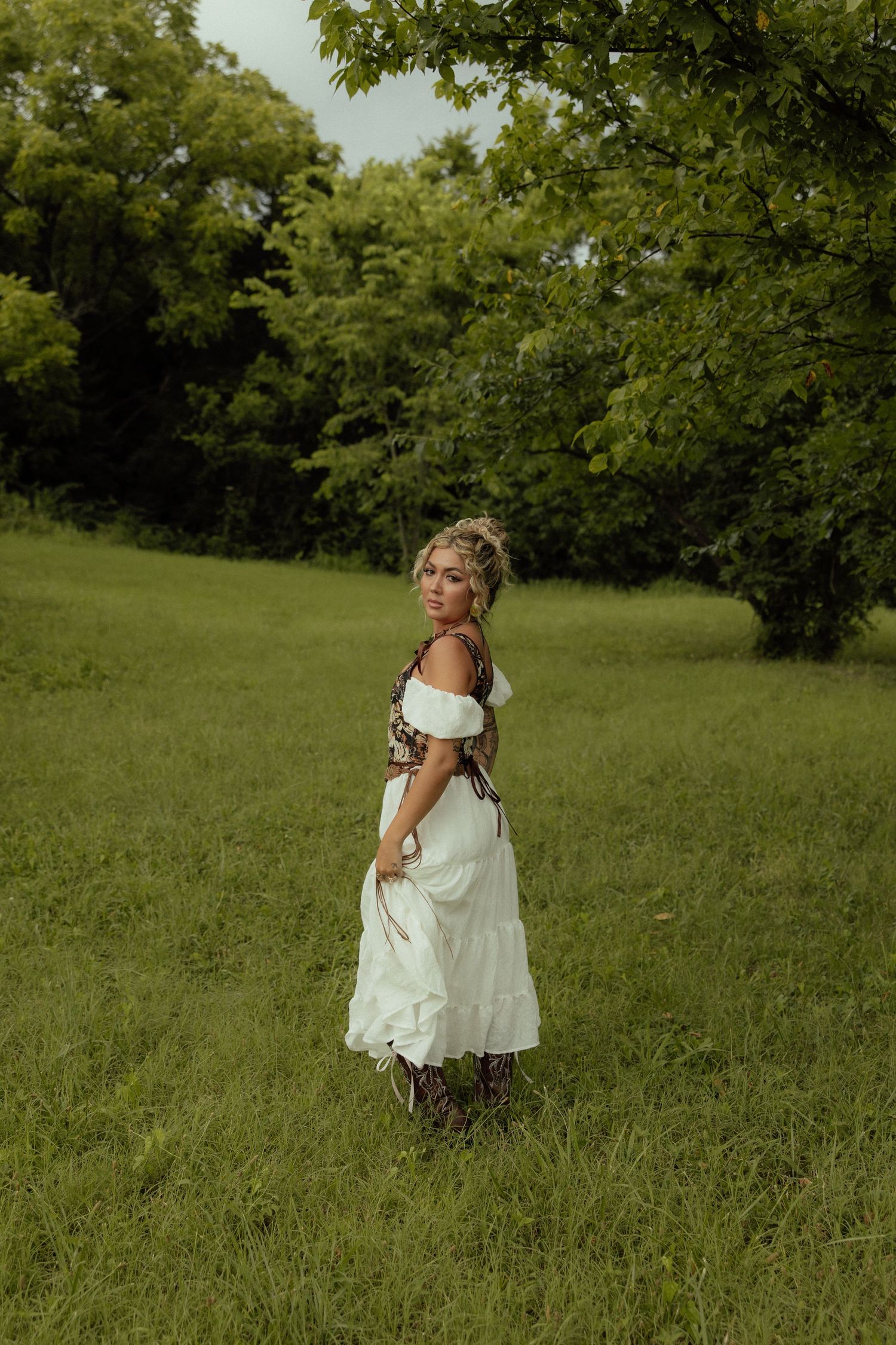 Ethereal shots of someone in a white dress dancing through a green summer field.