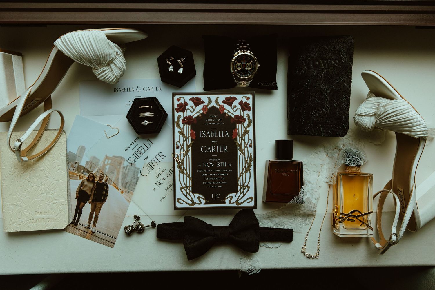 A collection of vintage objects and memorabilia arranged on a wall shelf including bottles, artwork, and decorative items.