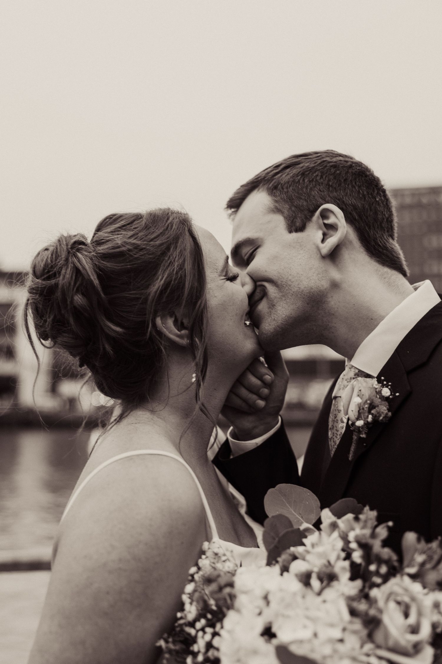 A sequence of romantic black and white wedding photos capturing tender moments between newlyweds.