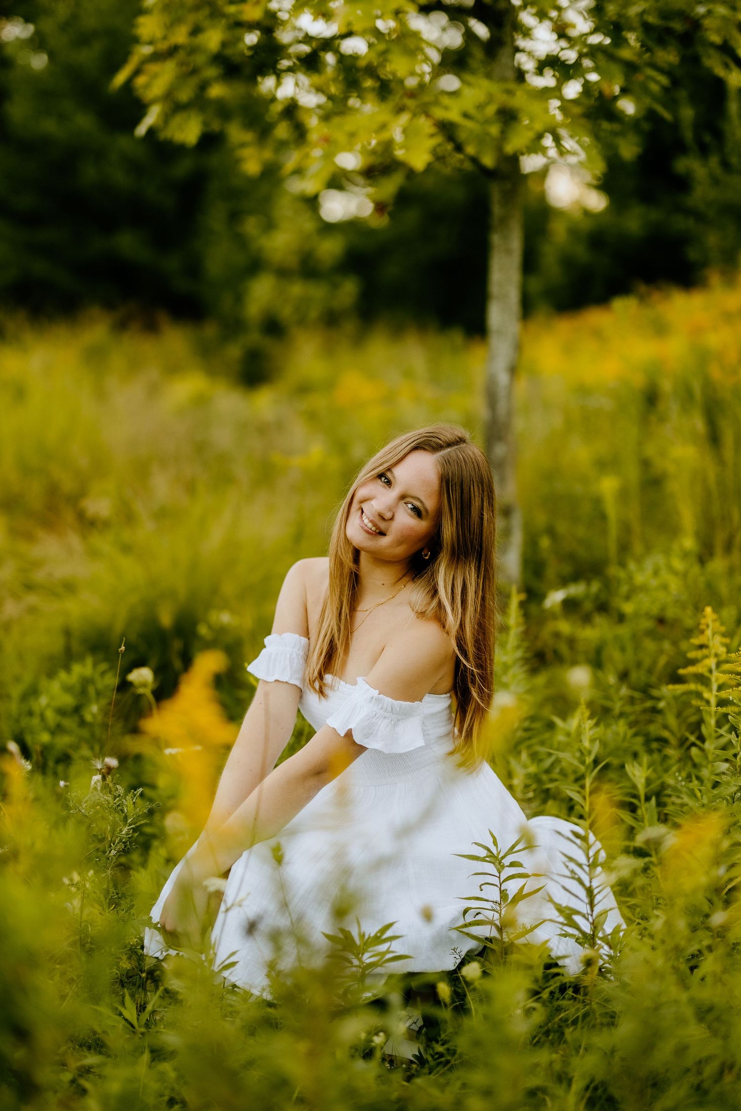 A white summer dress flows gracefully among tall wildflowers in a sunlit meadow.
