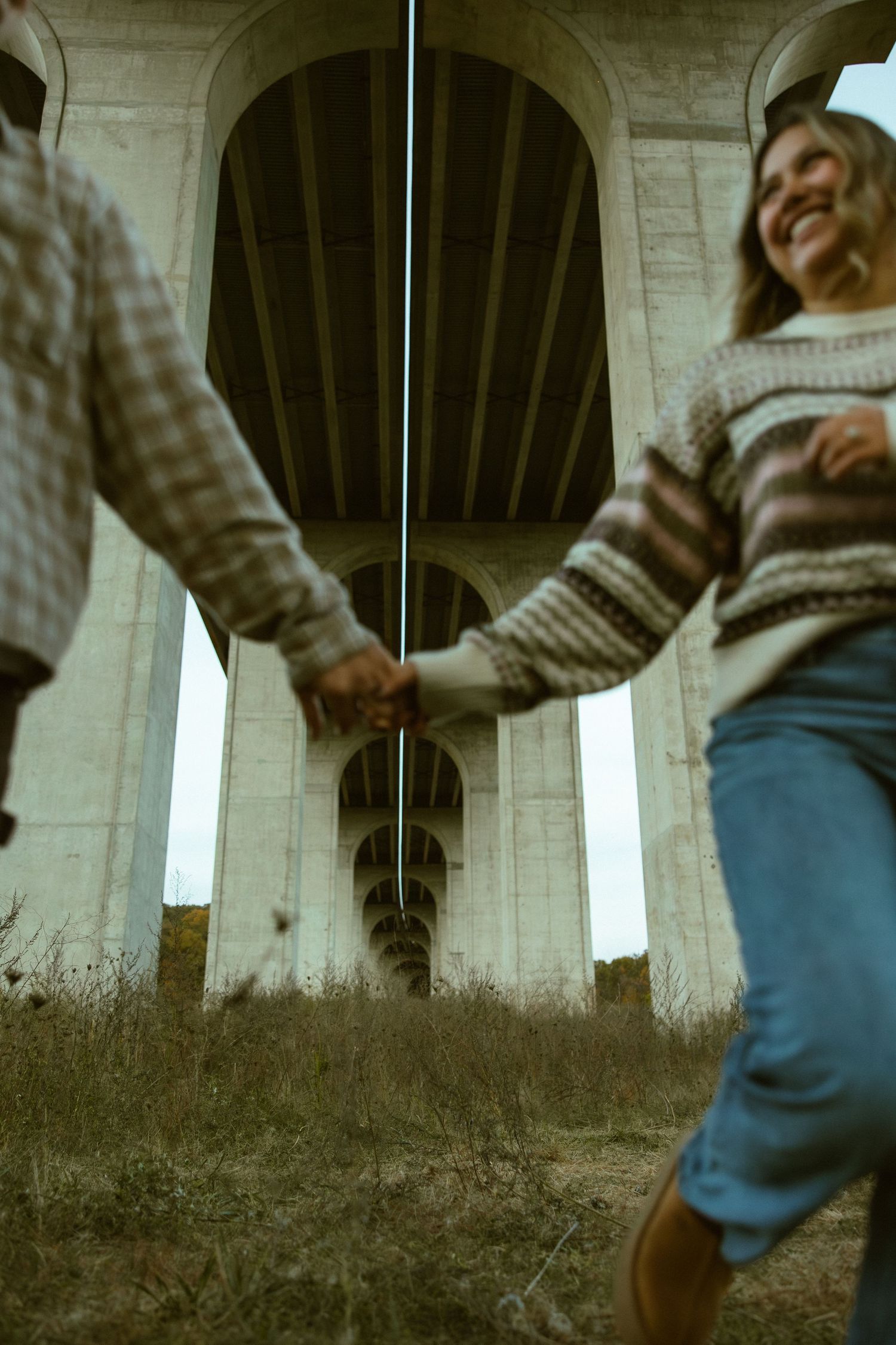 Sepia-toned sequence of someone walking beneath a concrete bridge or overpass structure.