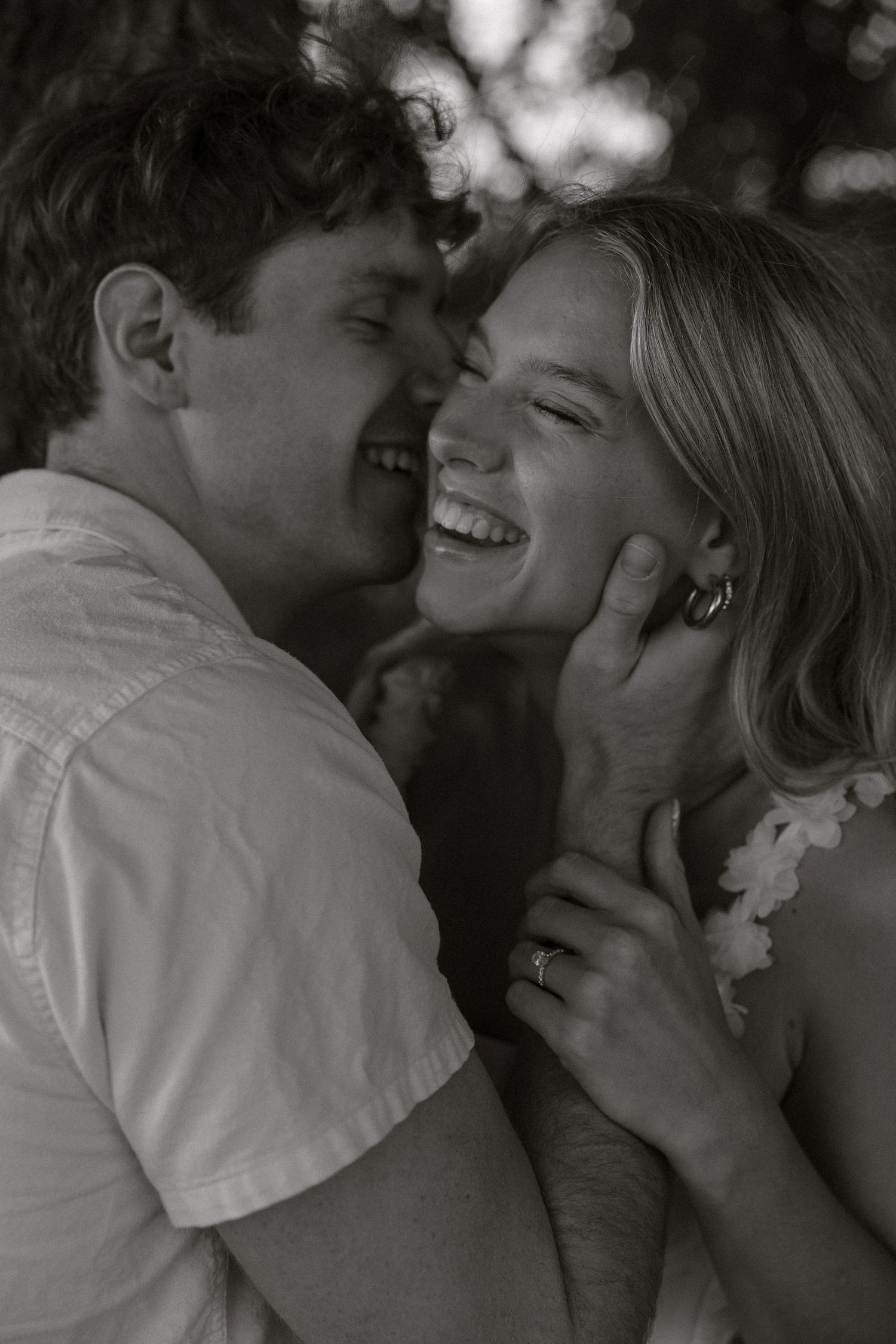 A romantic black and white photo series showing a couple sharing intimate moments and laughter together.
