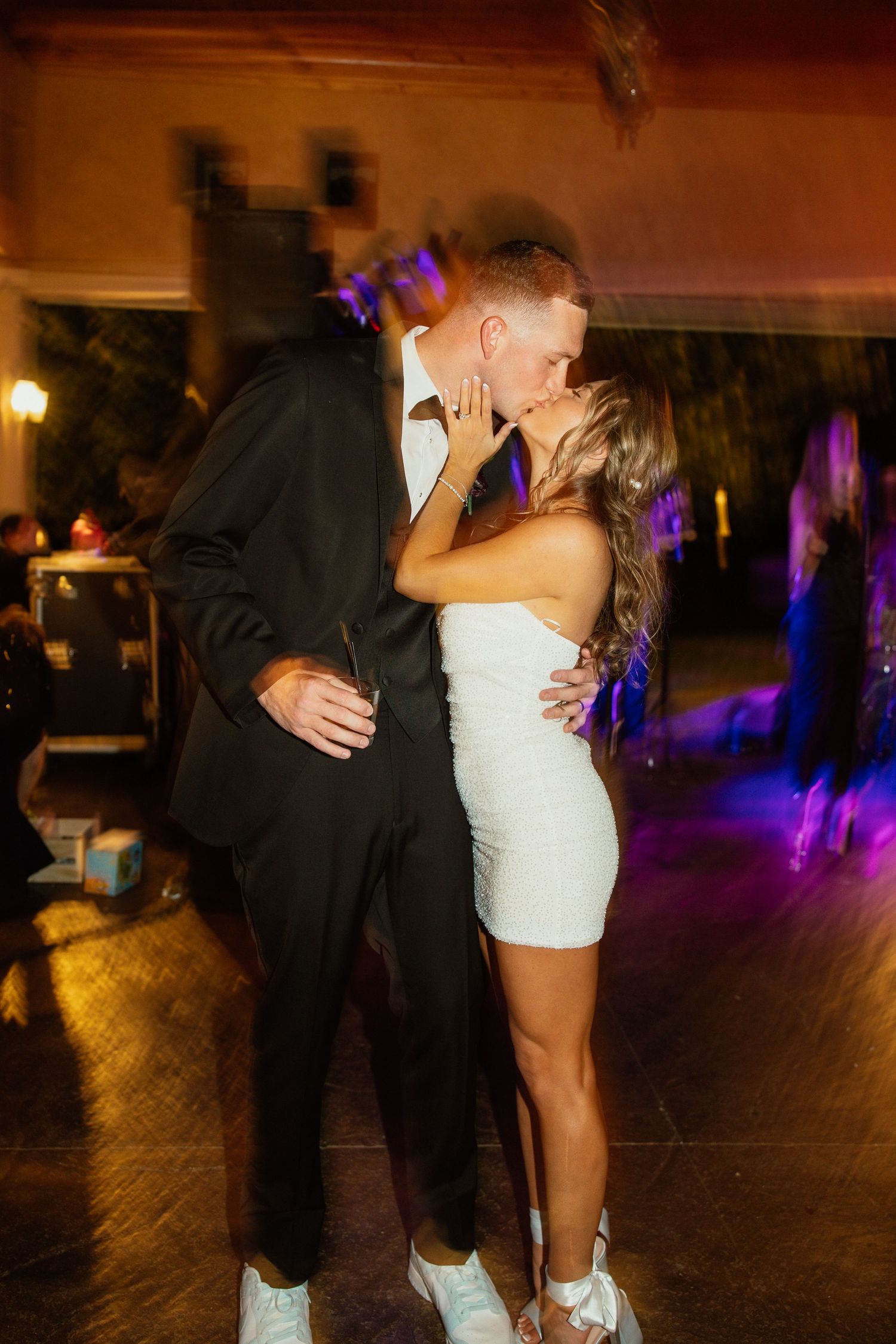 A romantic dance sequence captured in warm lighting at an evening wedding reception.