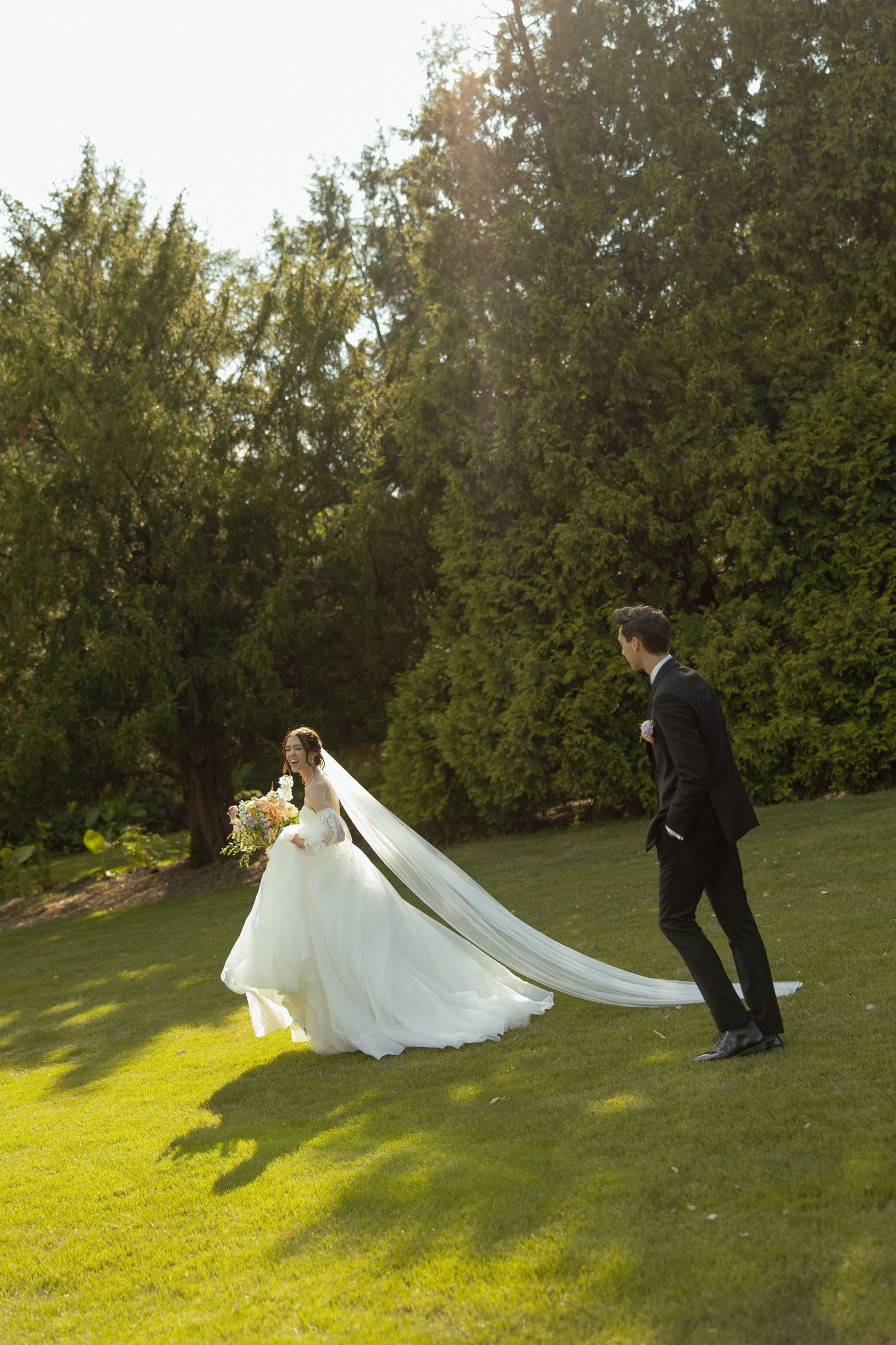 A sequence showing a wedding dress billowing dramatically in the wind on a sunny grassy hillside.