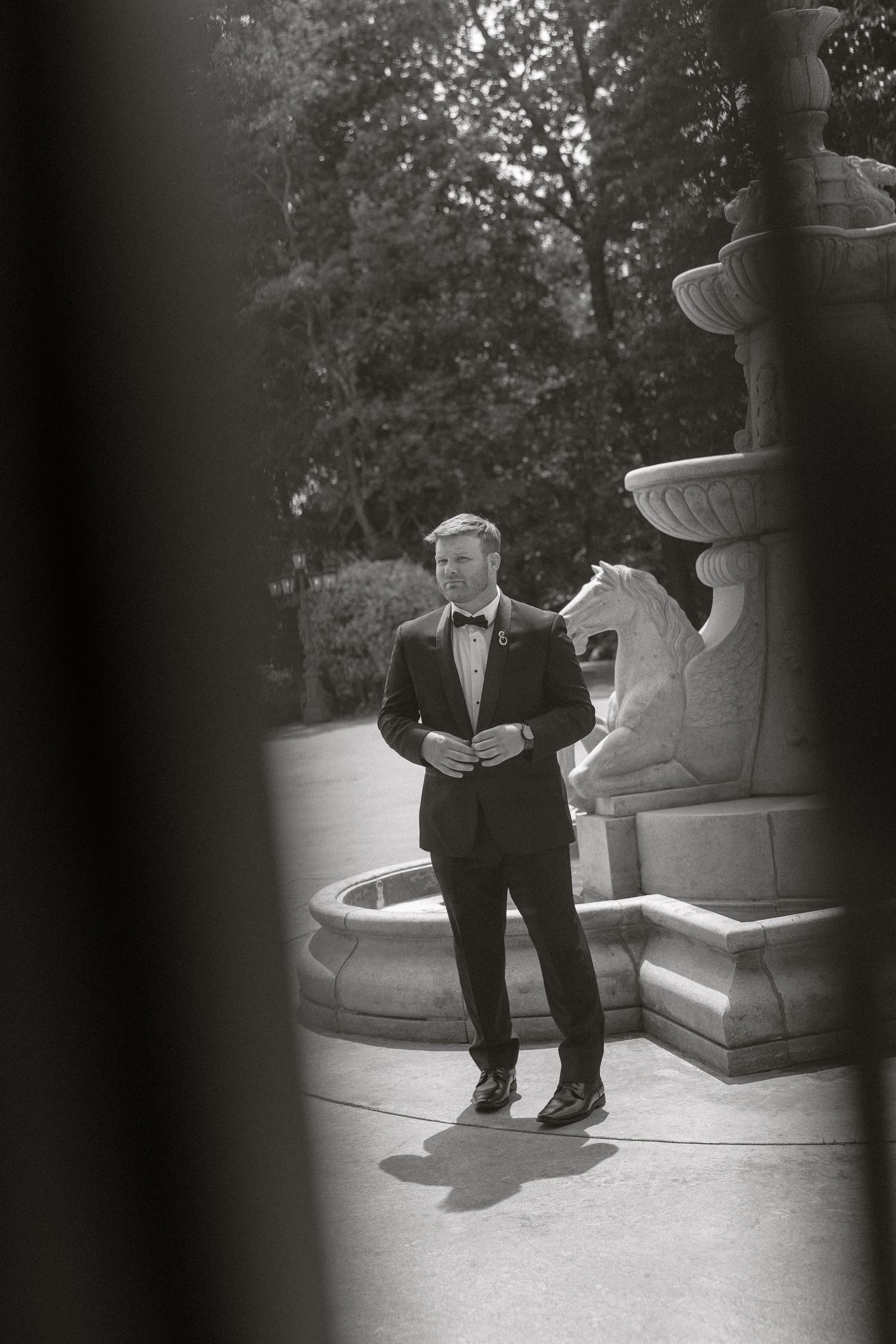 A series of black and white photographs showing a person in a suit sitting on outdoor steps in different poses.