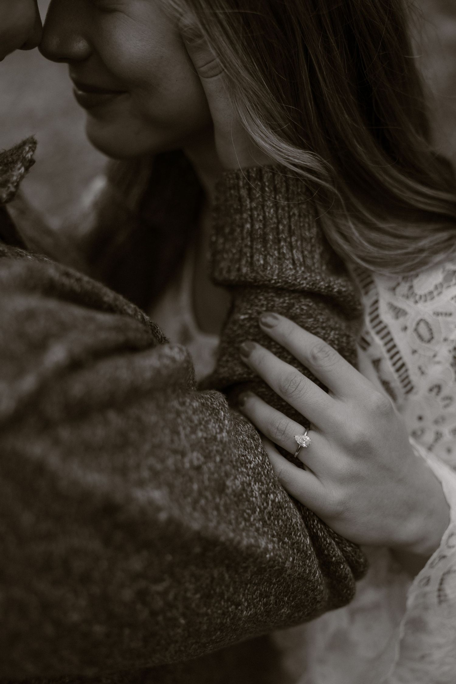 A close-up black and white photo series showing an engagement ring on a hand against a textured sweater background.