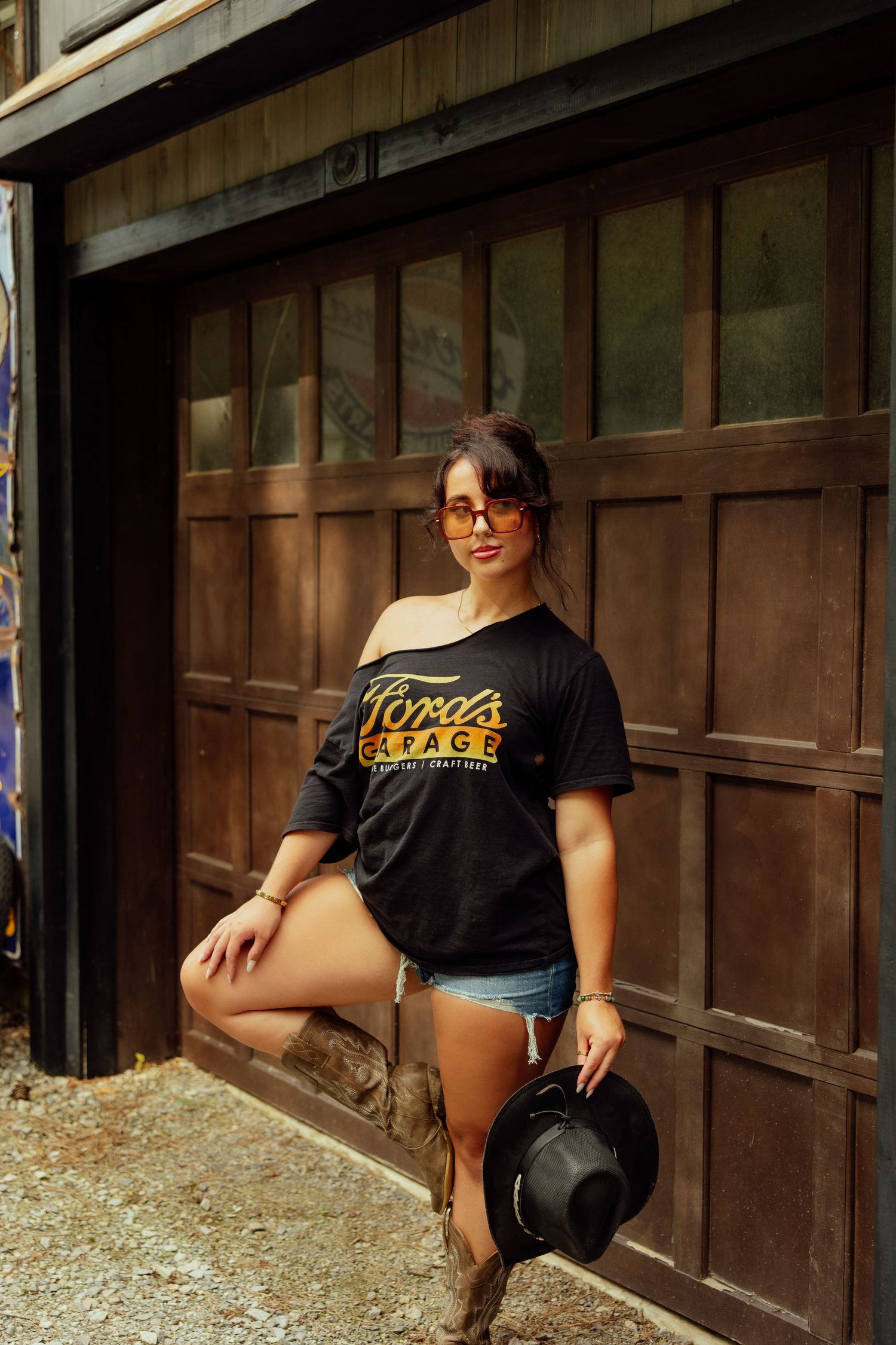 Artistic photo at a rustic wooden building with vintage style clothing and decor.
