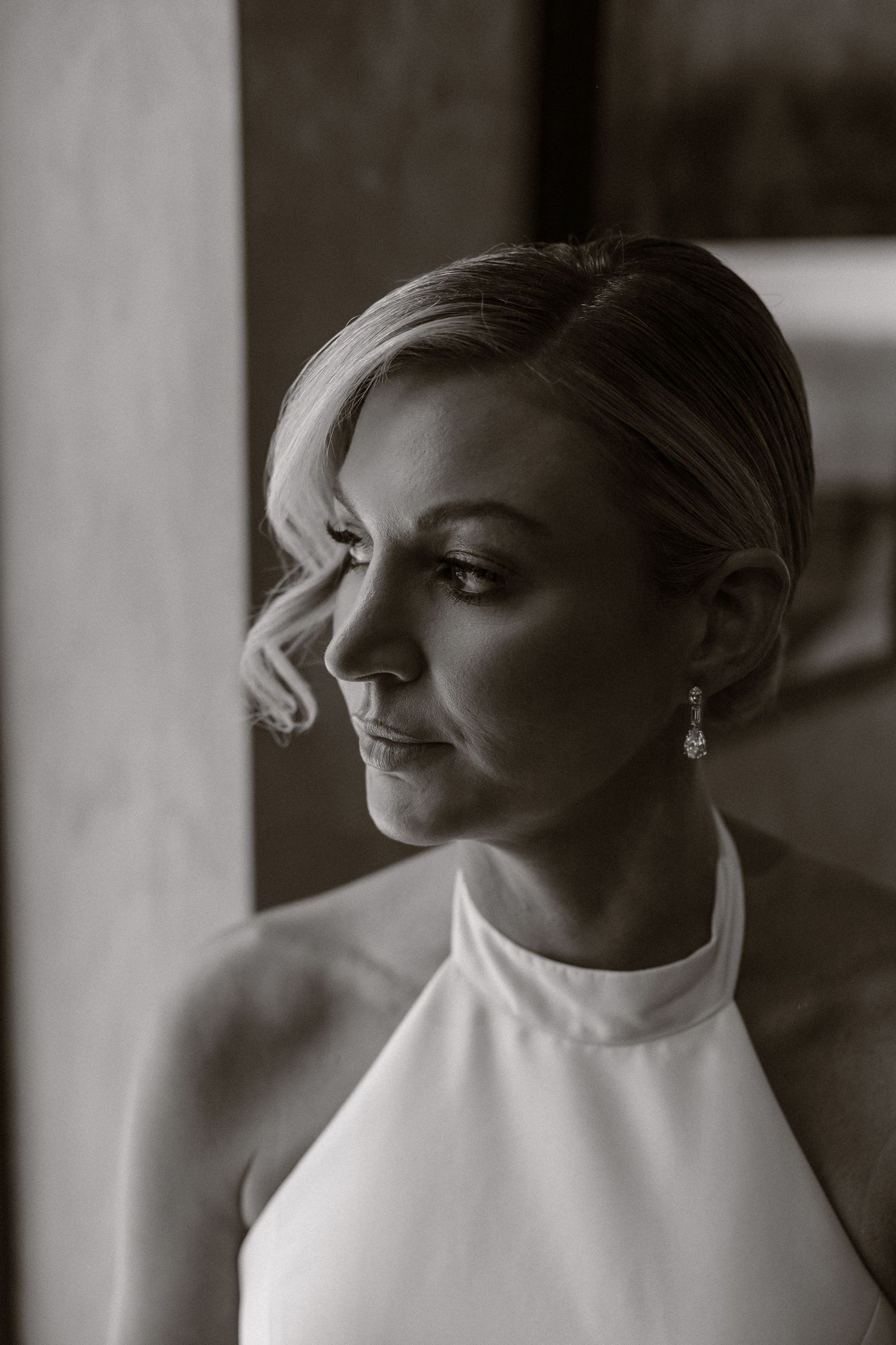 A series of black and white portraits showing elegant bridal styling with a classic updo hairstyle.