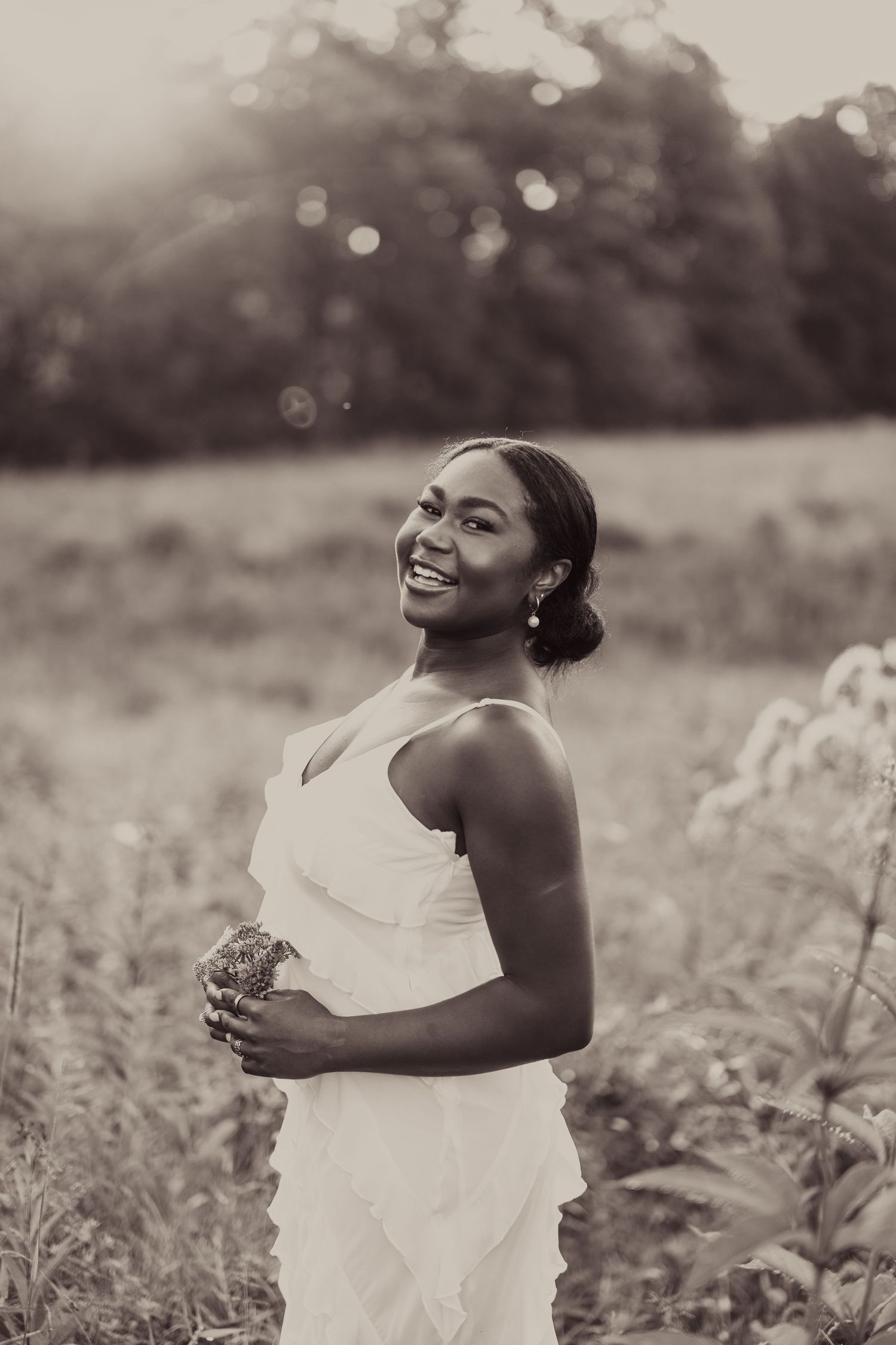 Black and white portrait in white dress outdoors with natural lighting.