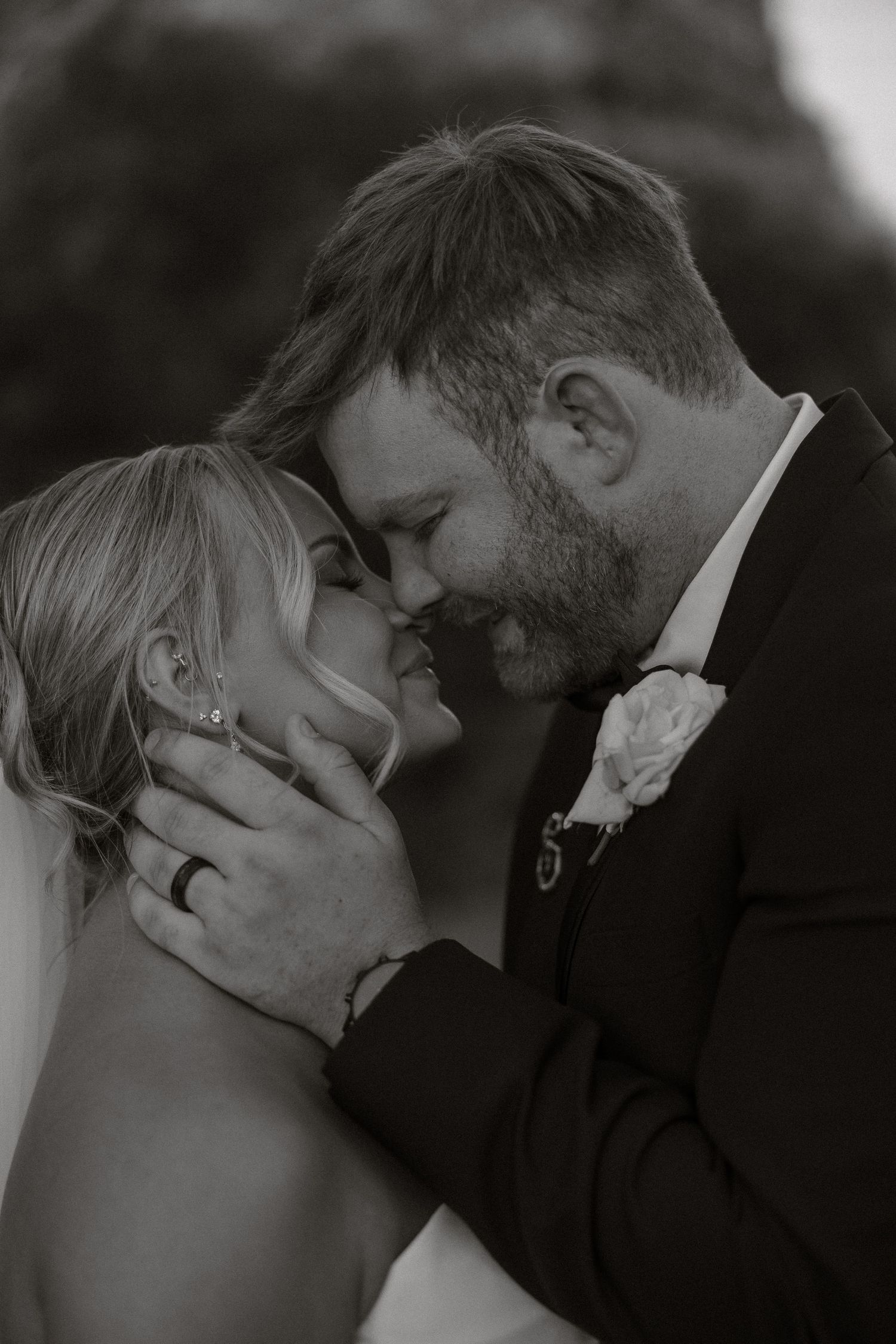 A romantic black and white photo series showing tender moments between a couple sharing intimate kisses.
