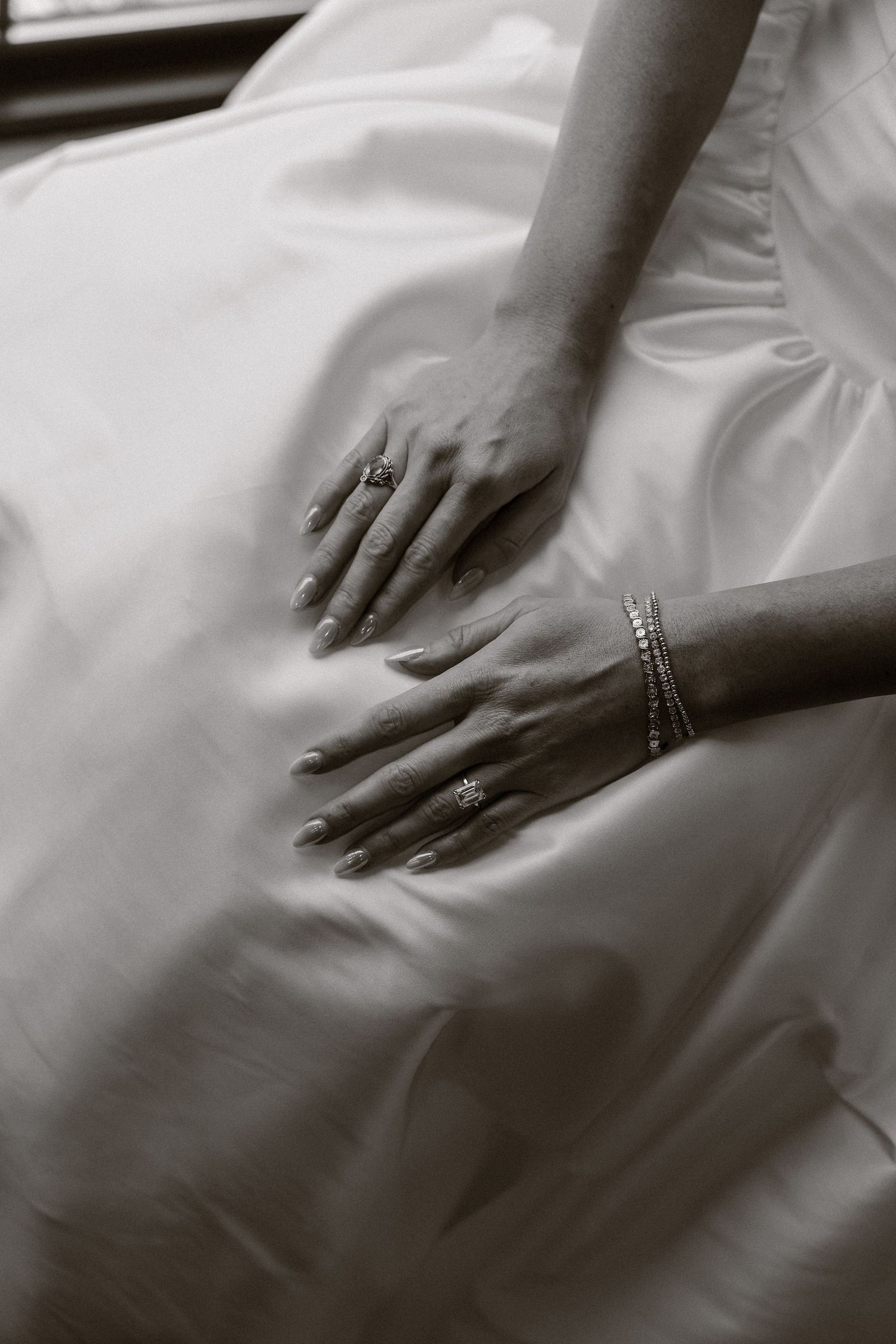 Close-up sequence of hands with engagement ring and wedding band against white fabric showing different poses and angles.