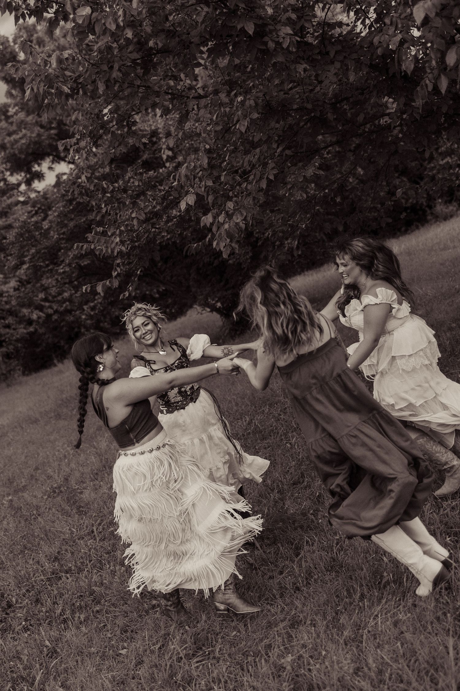 A sequence of vintage black and white photographs showing people lying in grass, creating an artistic motion effect.