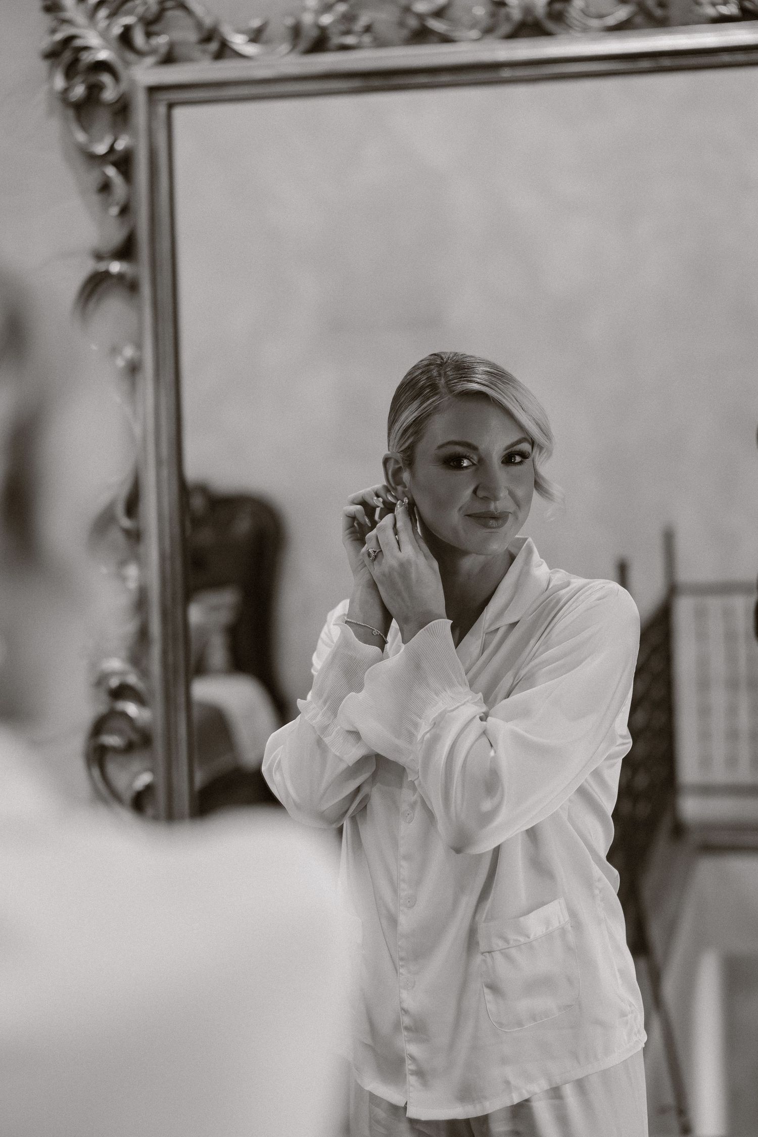 A series of black and white photos showing someone in a white robe getting ready.
