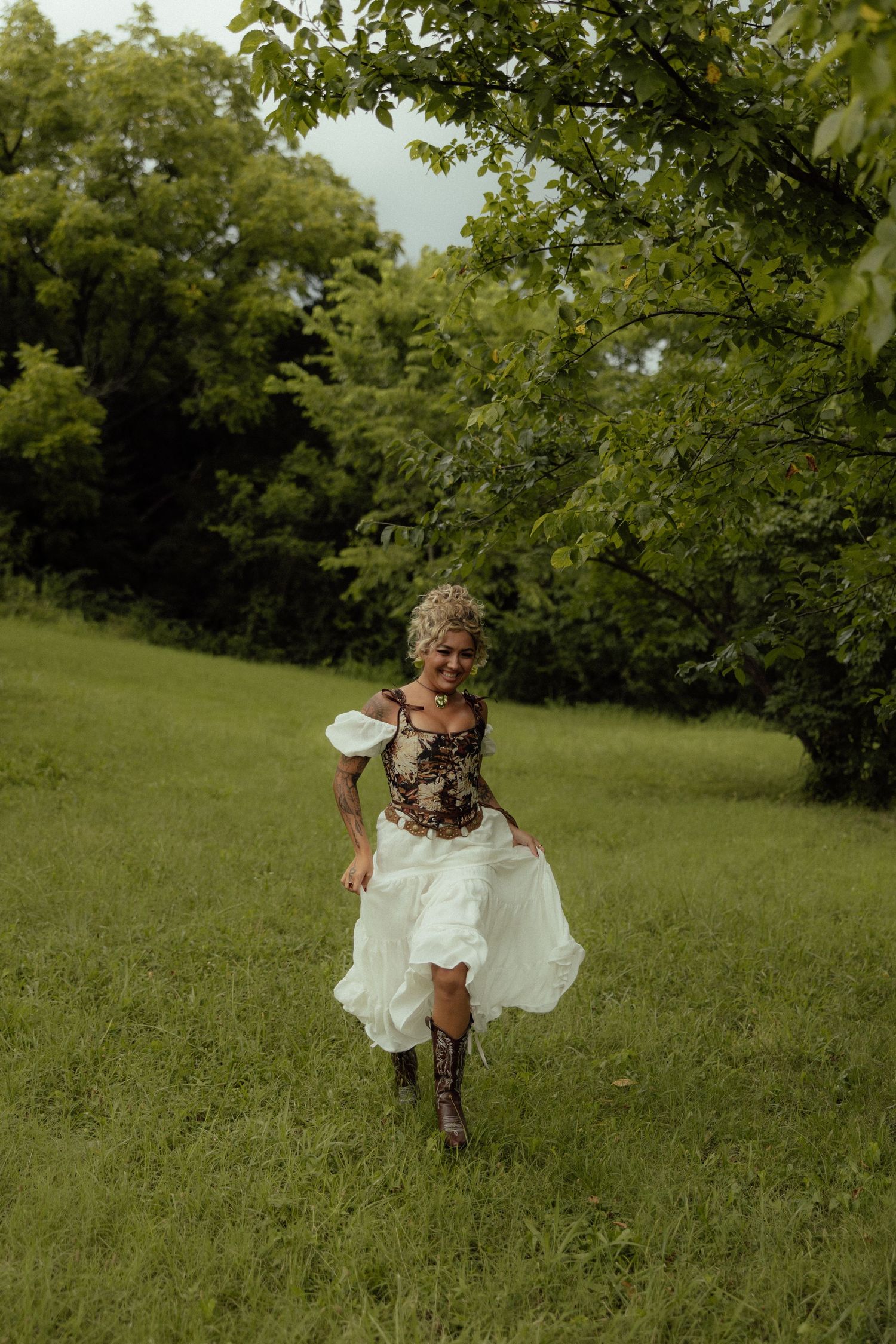 A sequence of photos shows someone in a white dress and cowboy boots running playfully through a green field.