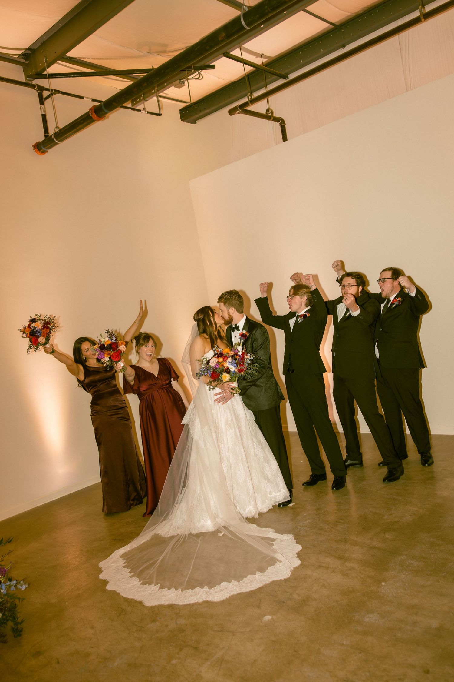 Wedding party lined up in a reception venue takes a celebratory drink together in a sequence of four candid photos.