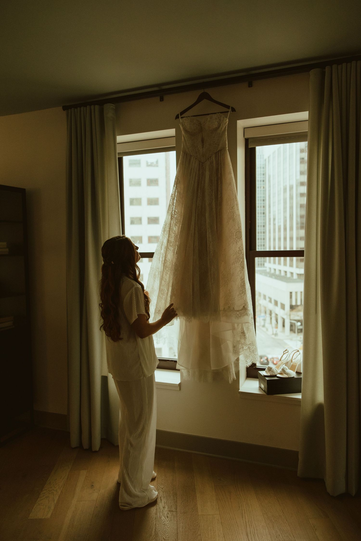 Artistic series of silhouetted figures adjusting curtains in a sunlit room with wooden floors.