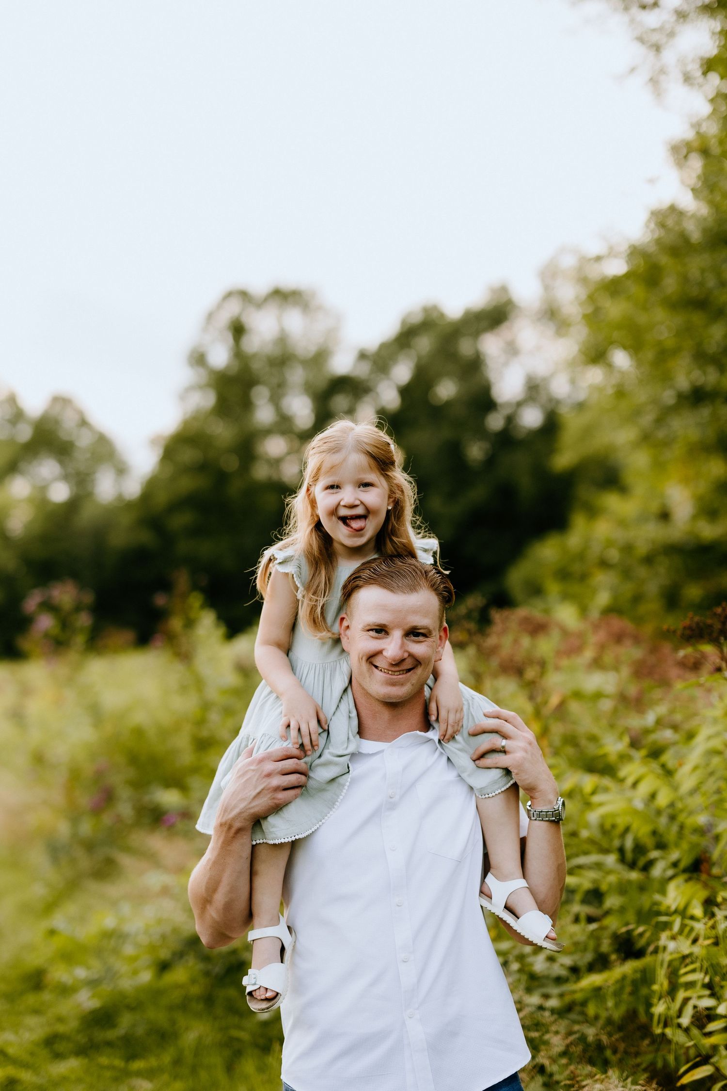 Joyful piggyback ride moment captured in sunny outdoor setting.