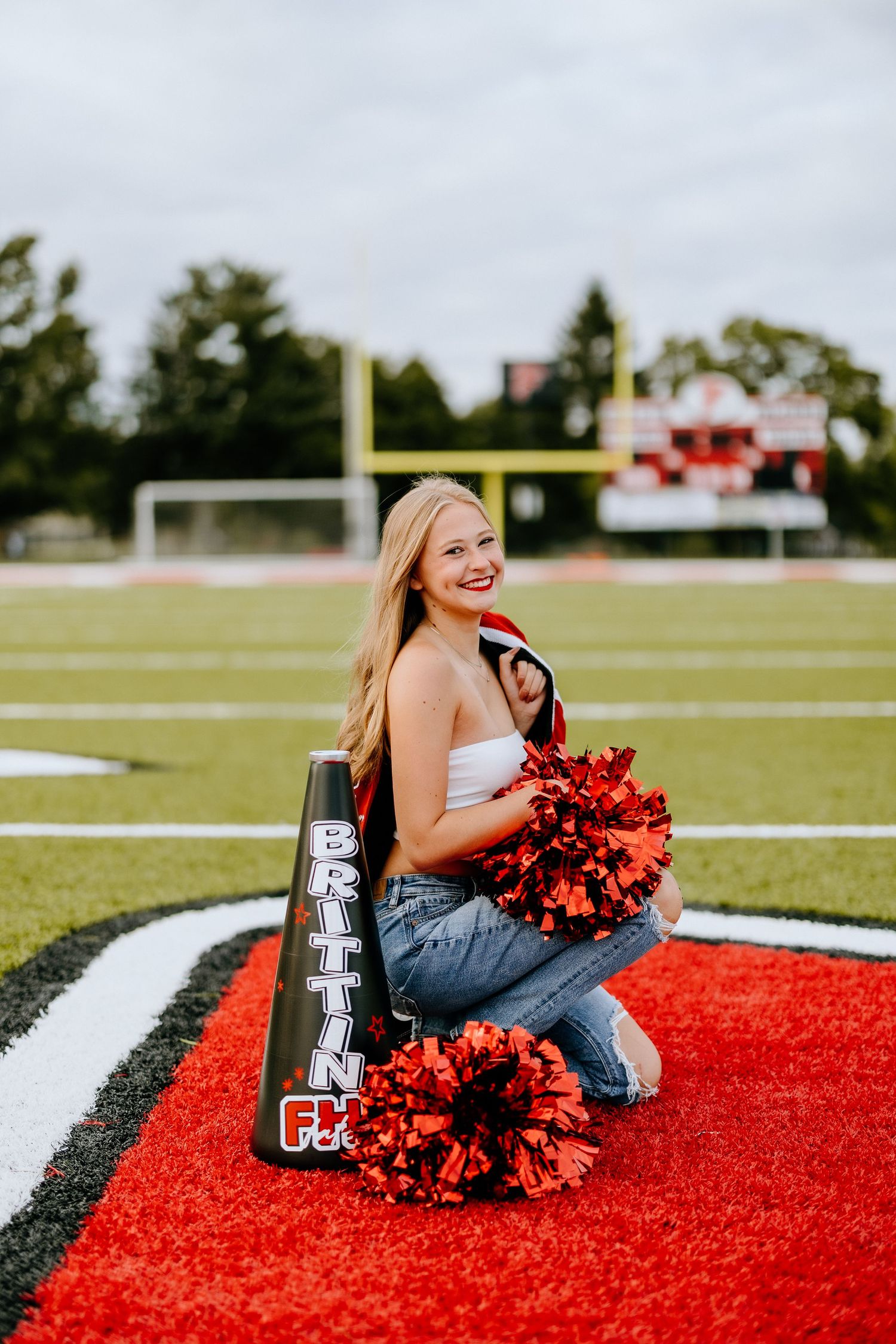 Athletic field portrait with red and black decorative elements.