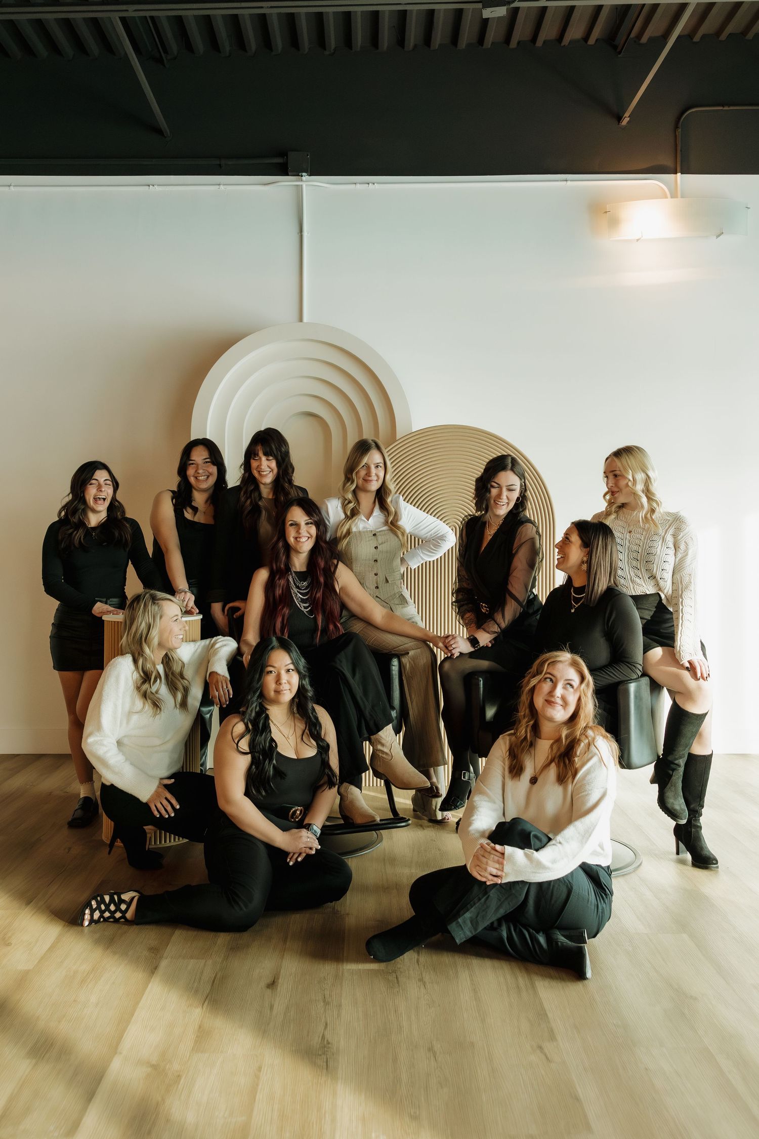 Artistic group photo in a modern studio with geometric wall decor and hardwood floors.