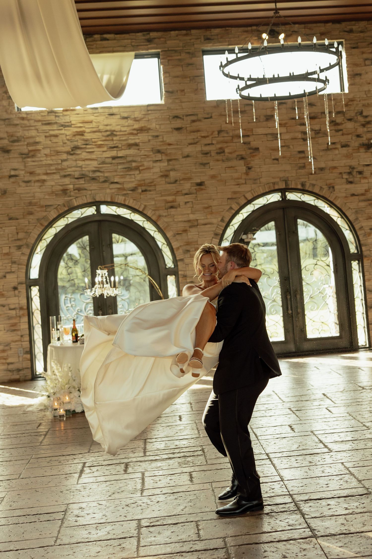 A sequence showing a dramatic wedding dance dip with the bride's dress flowing across a tiled ballroom floor.