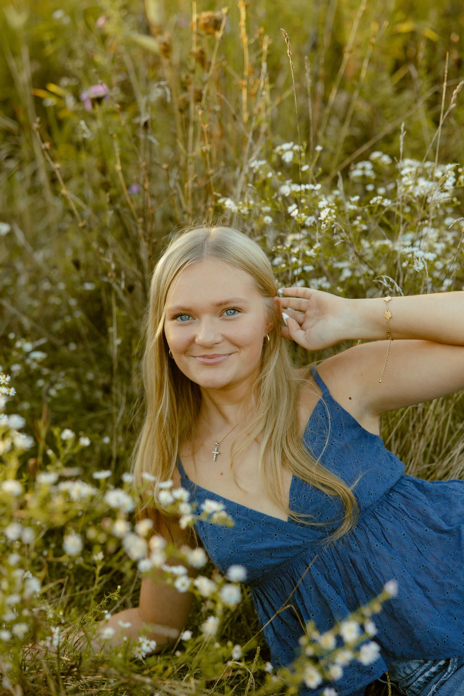 A summer portrait session in a wildflower field with white daisies and natural golden light.