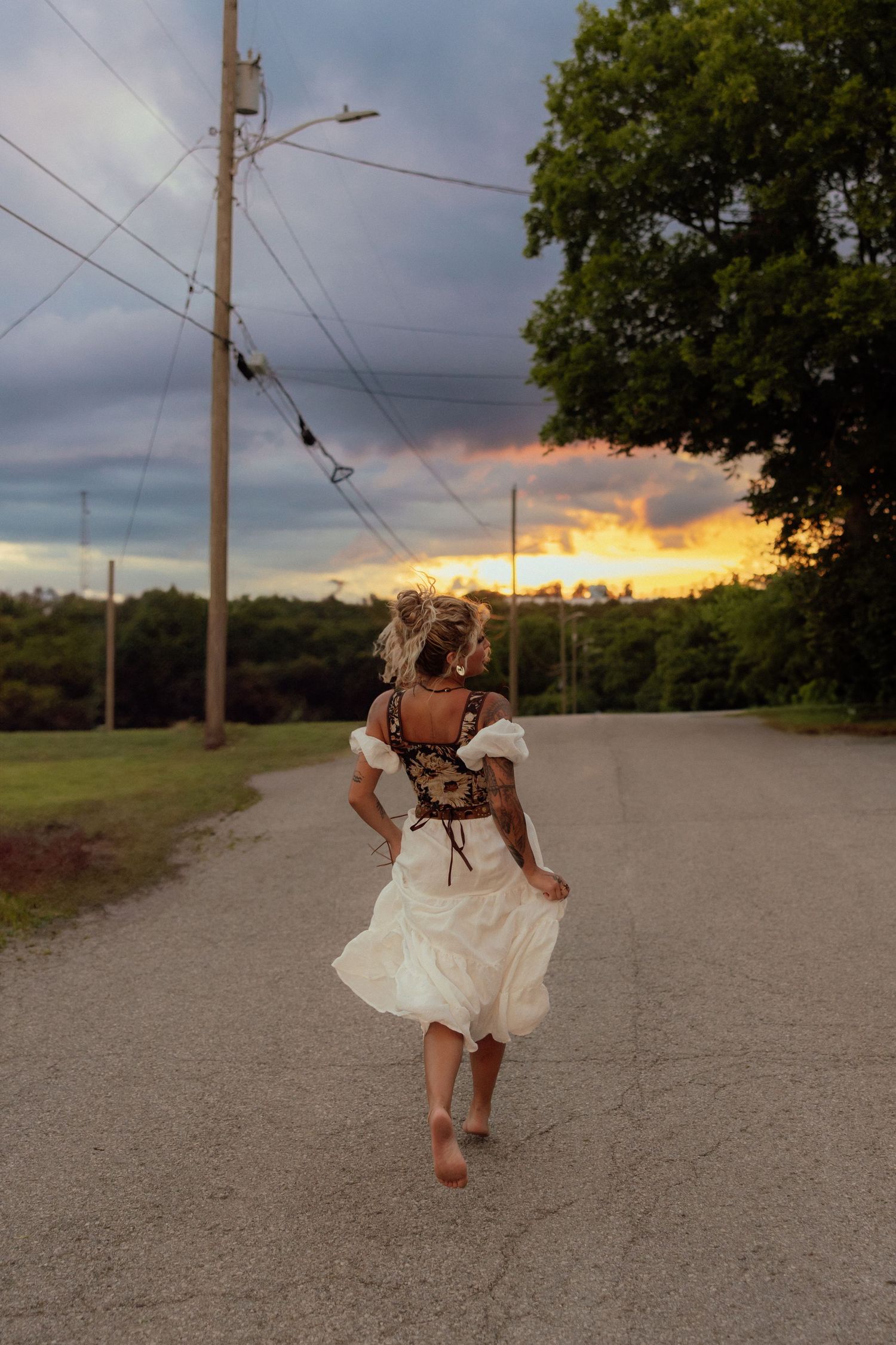 A sequence of artistic photos showing a white dress flowing in motion against a sunset sky with utility poles.
