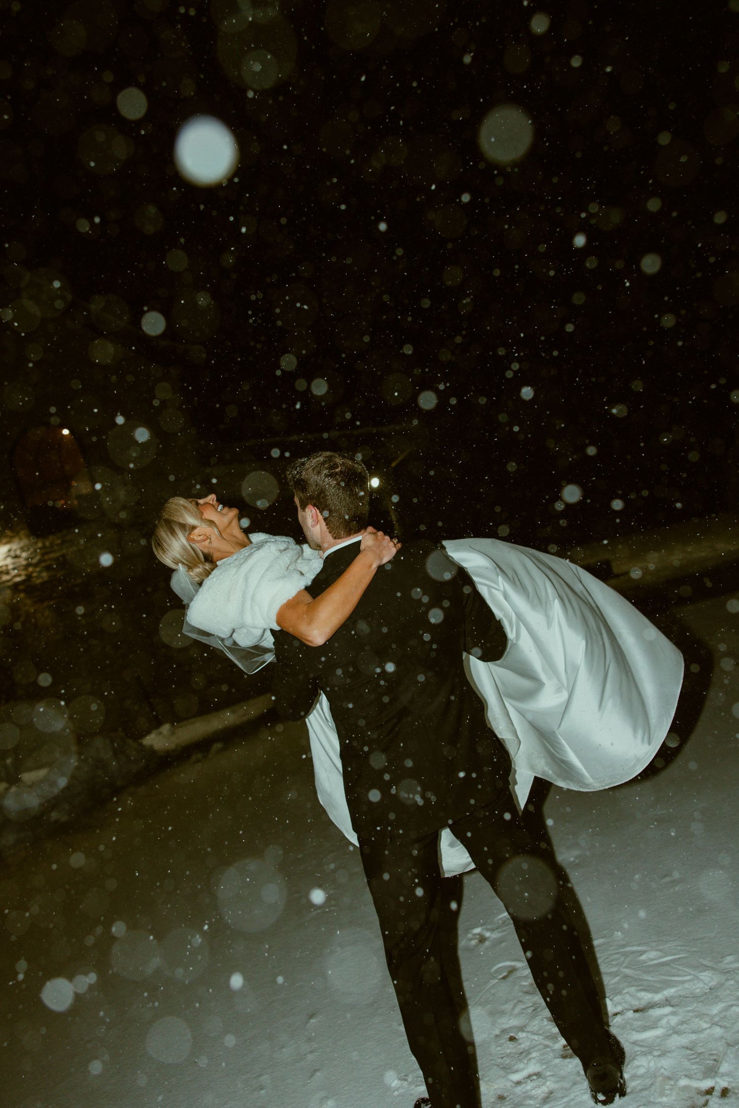 A sequence of playful dance moves in the snow at night with falling snowflakes creating a magical winter atmosphere.