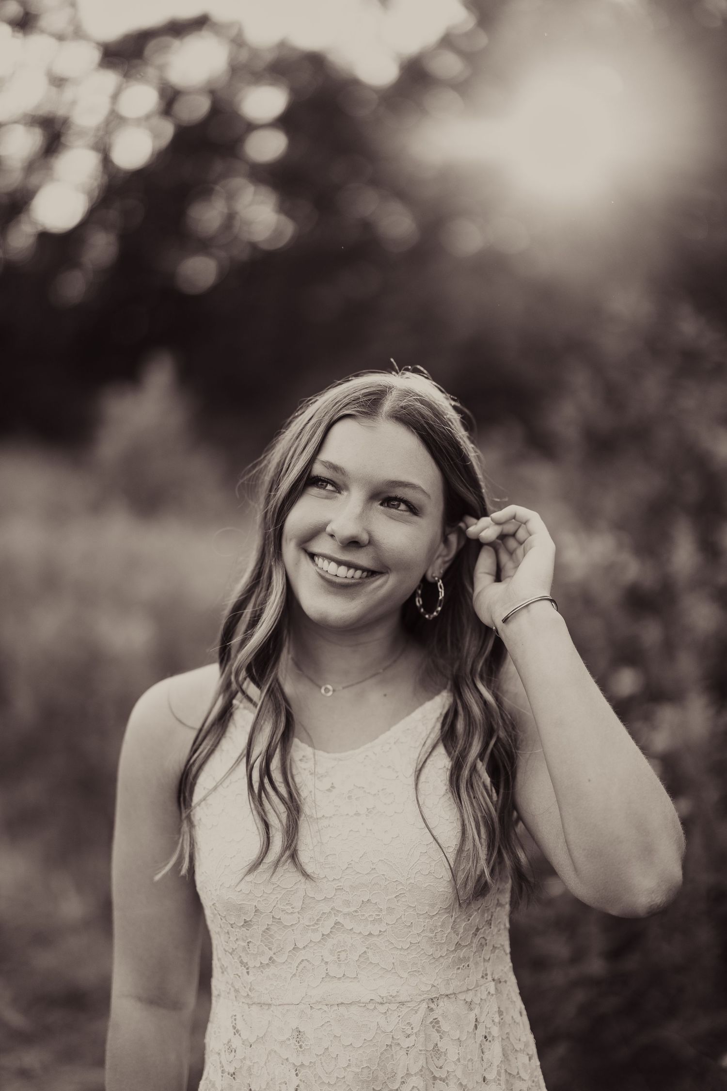 A vintage-style black and white portrait capturing soft bokeh lighting effects.