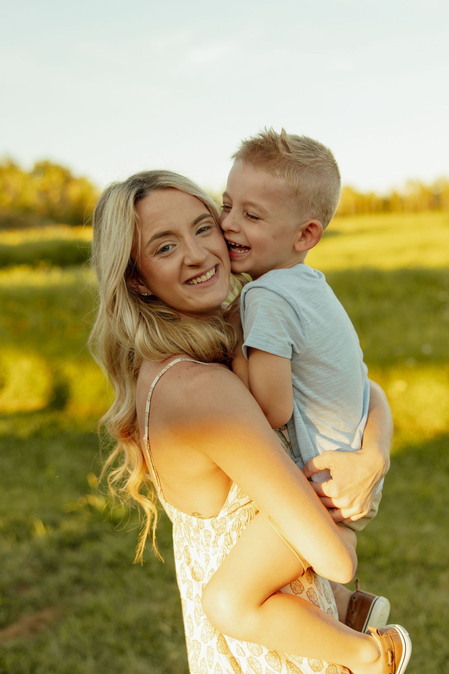 A tender moment shared between parent and child in a sunlit meadow at golden hour.