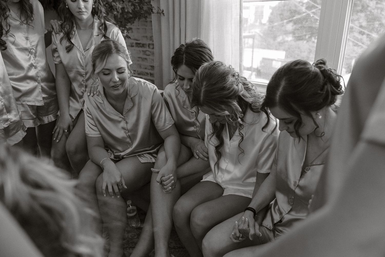 A black and white photo montage shows people in various candid moments of laughter and conversation.