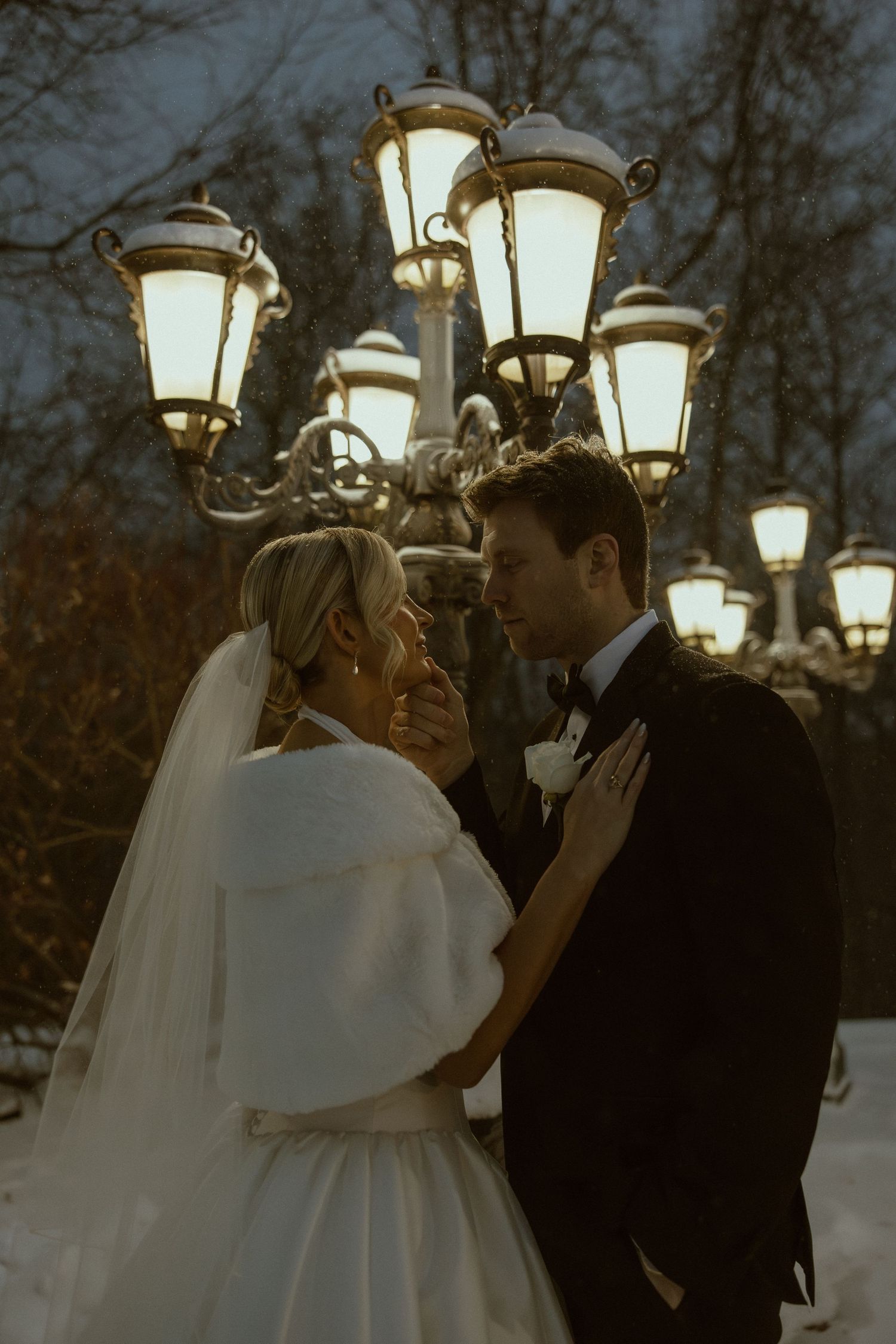 A romantic evening wedding scene with vintage lanterns glowing in the background.